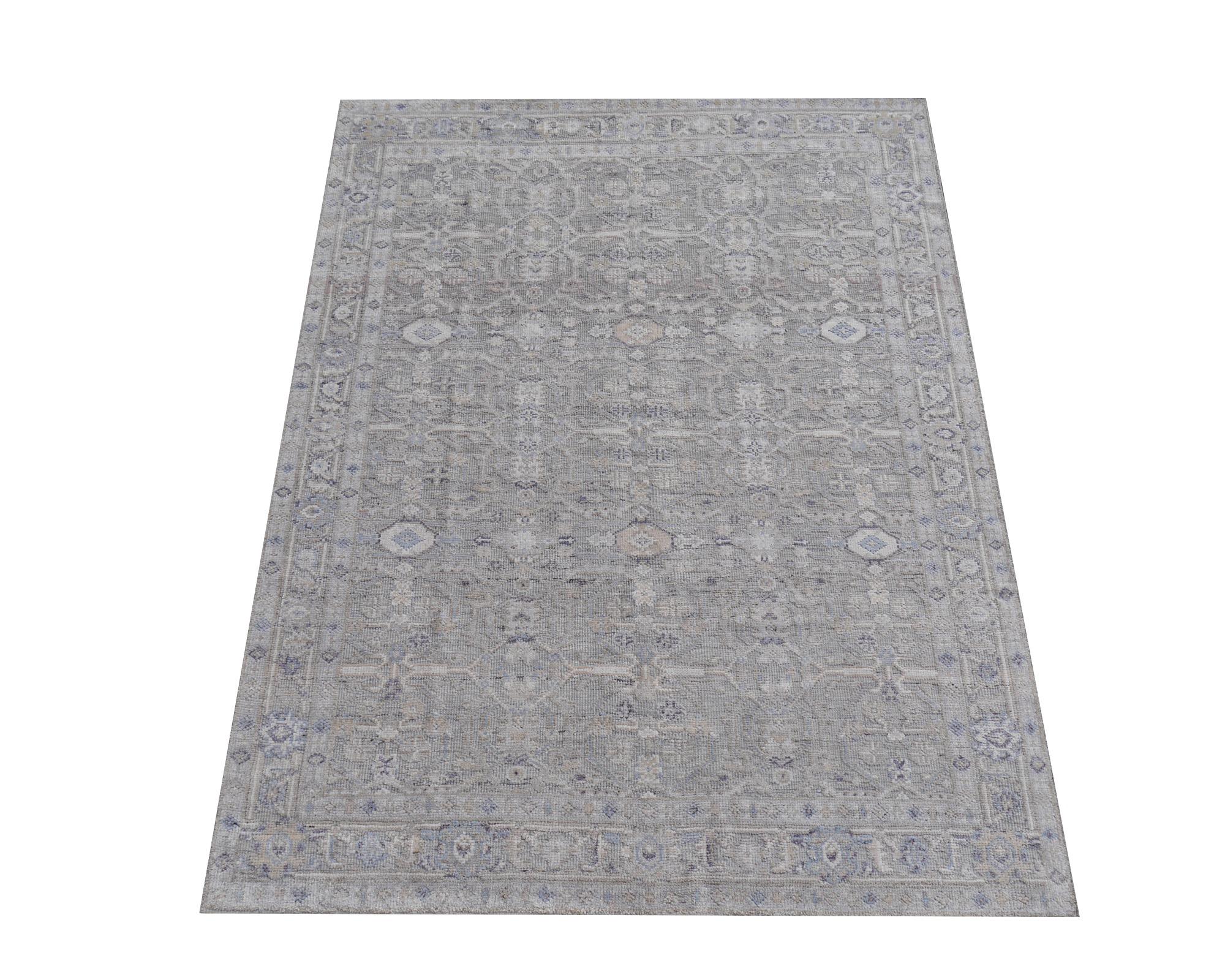 A beautiful 14 x 10 ft. modern rug hand knotted wool pile and bamboo silk in trending interior design shades. On a light grey field, the design in style of traditional Oushak and Heriz elements standing next to each other executed in silver, blues