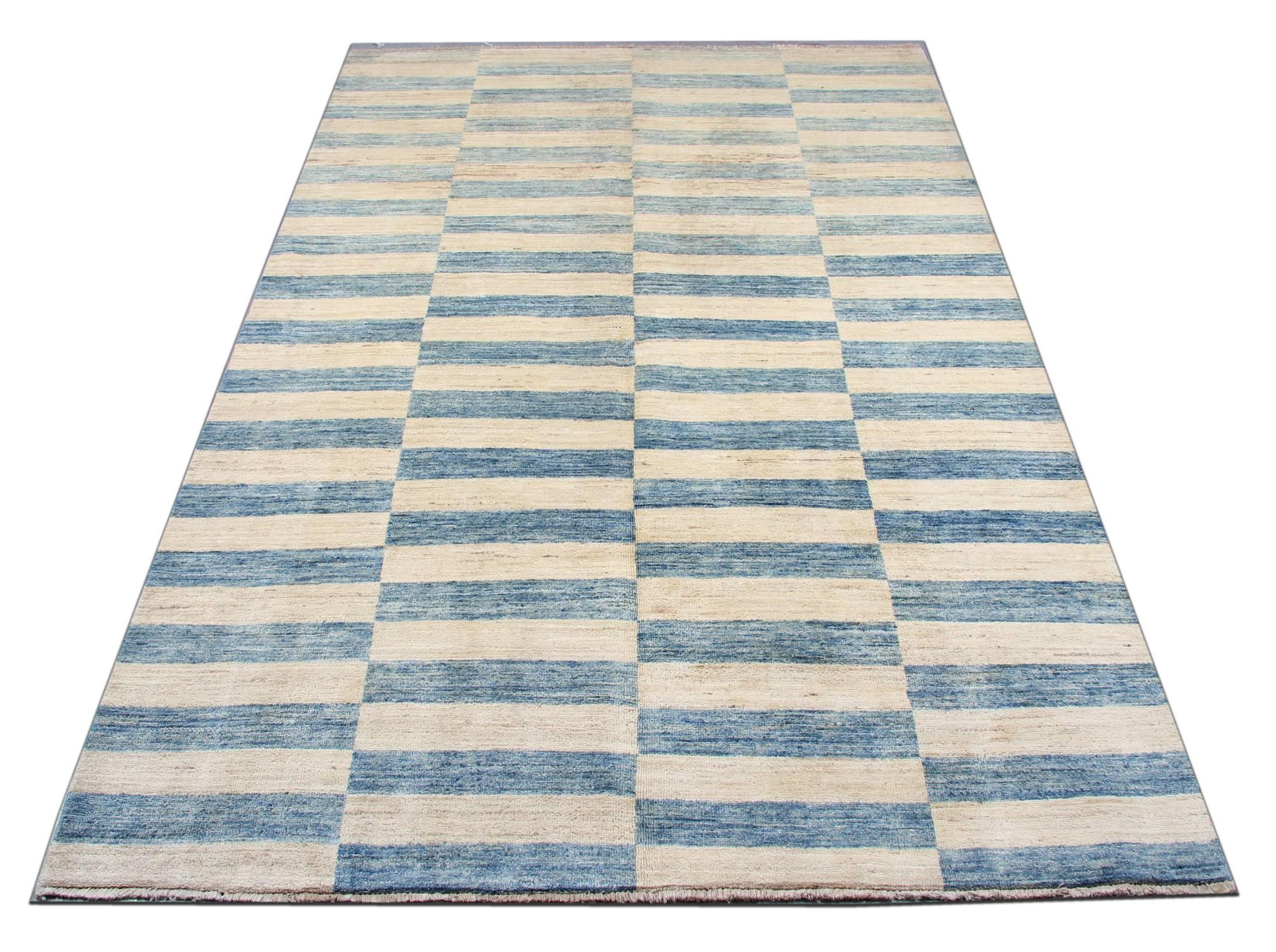 With nice blue and abstract element, this striped rug gives a subtle contemporary appearance. The geometric rug is featuring a beautiful sky palette of blue and ivory. This blue rug is grounded in stylish colors that will add a touch of modernized