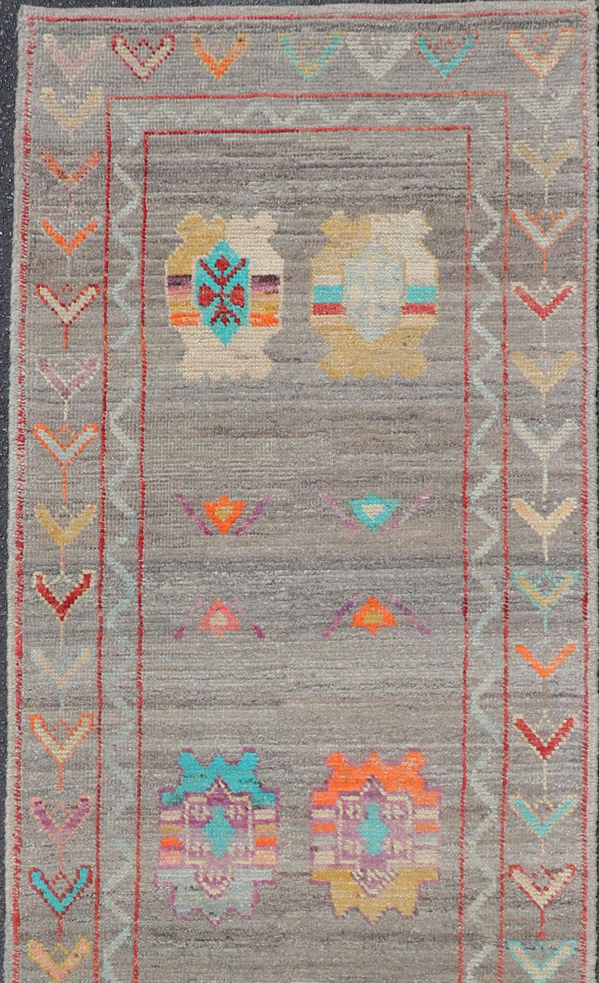 Fine Afghan made, Tribal designed runner in gray and vivid color palette and all-over geometrics Keivan Woven Arts/rug AFG-36122, country of origin / type: Afghanistan / Modern

Measures: 2'8 x 9'7 

This modern rug features a subdued, gray