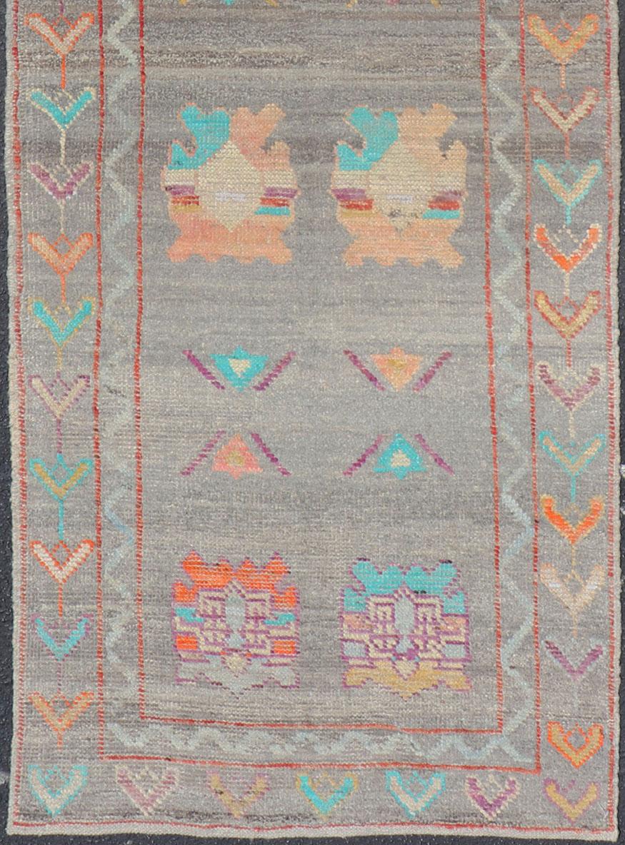 Hand-Knotted Modern Runner with Tribal Motifs in Warm Gray Background and Vivid Multi Colors For Sale