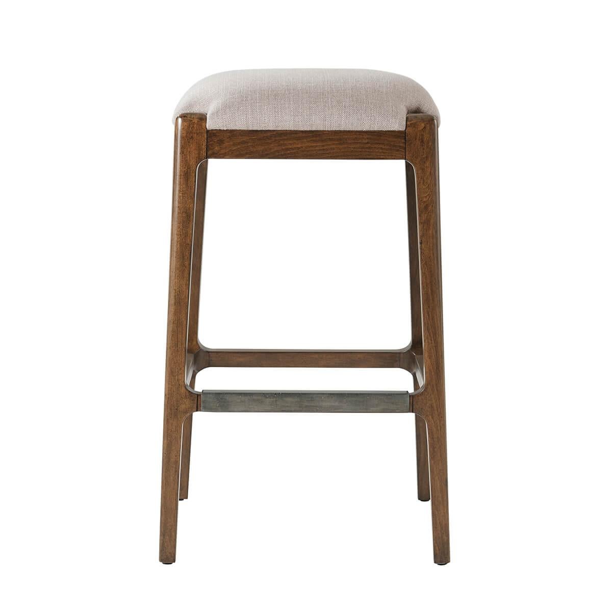 with an upholstered cushion seat covered in performance fabric, on splayed tapering legs joined by a stretcher in a slightly distressed warm color finish.

Dimensions: 18