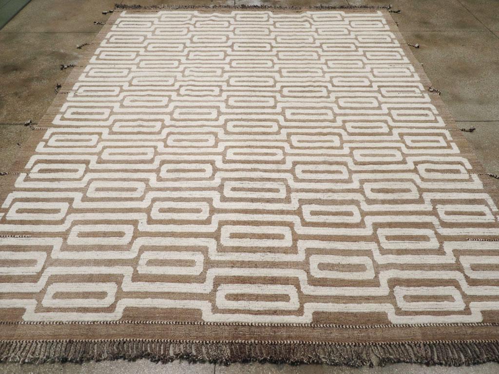 A new modern rustic style Turkish room size carpet in brown and cream with side tassels and a high/low design consisting of a flat background and raised pattern.

Measures: 10' 9