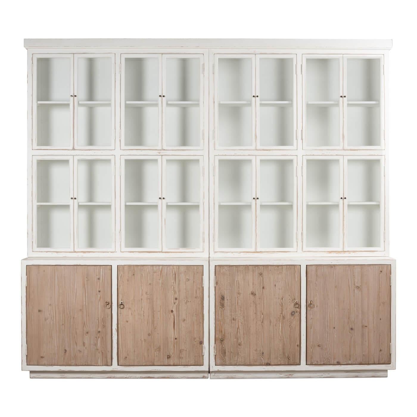Modern rustic white and natural wood bookcase. The perfect piece for storage and display. The upper cabinet is actually comprised of 8 small compartmental cabinets, each with windowpane-style doors. The base cabinet has 4 natural pine