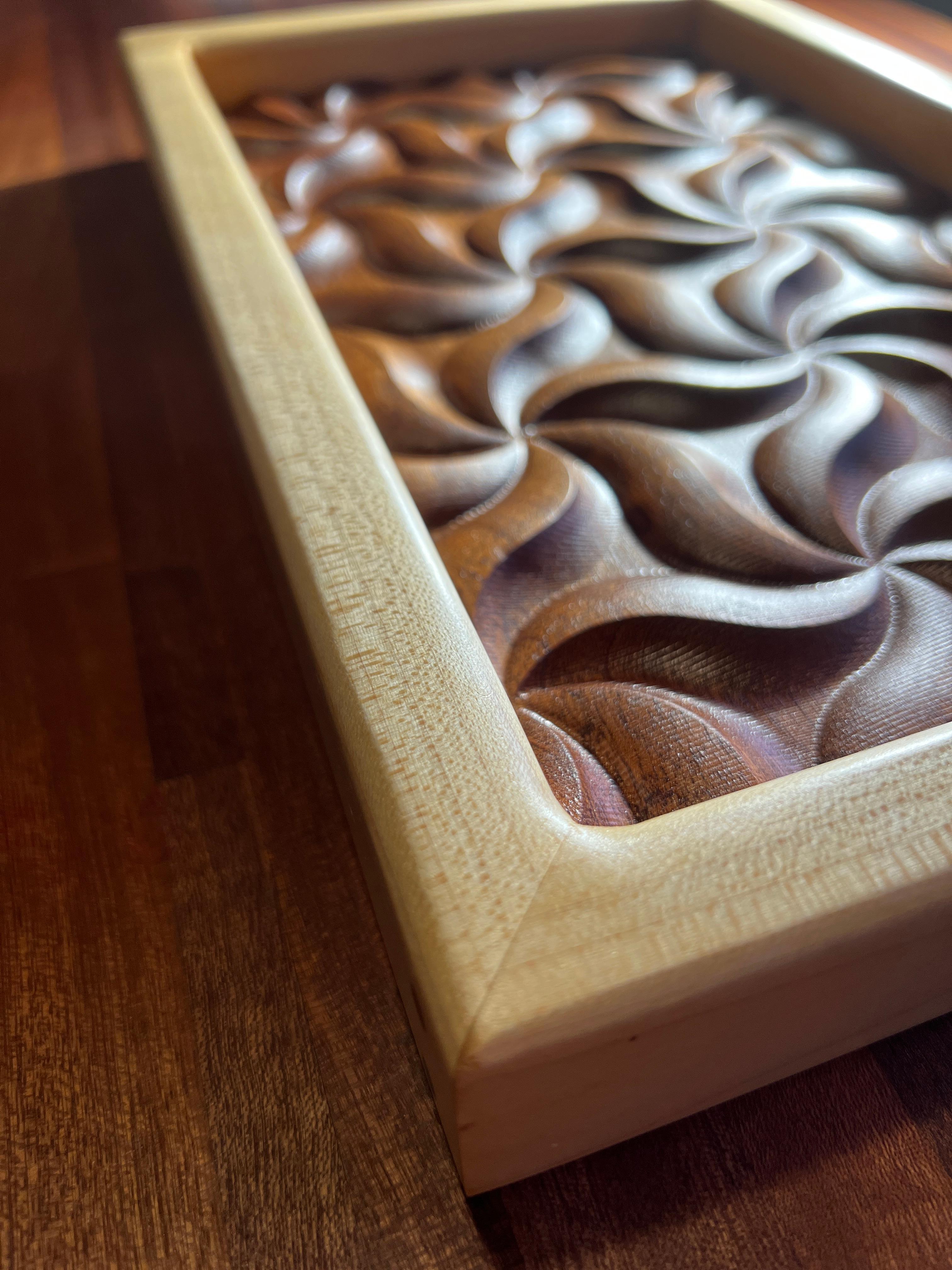 This stylish artisan Vide-Poche was made just for you from solid Sapele wood and clear maple. This piece was designed and created with extreme valleys and peaks to capture morning, afternoon and evening light. The lighting casts shadows and patterns