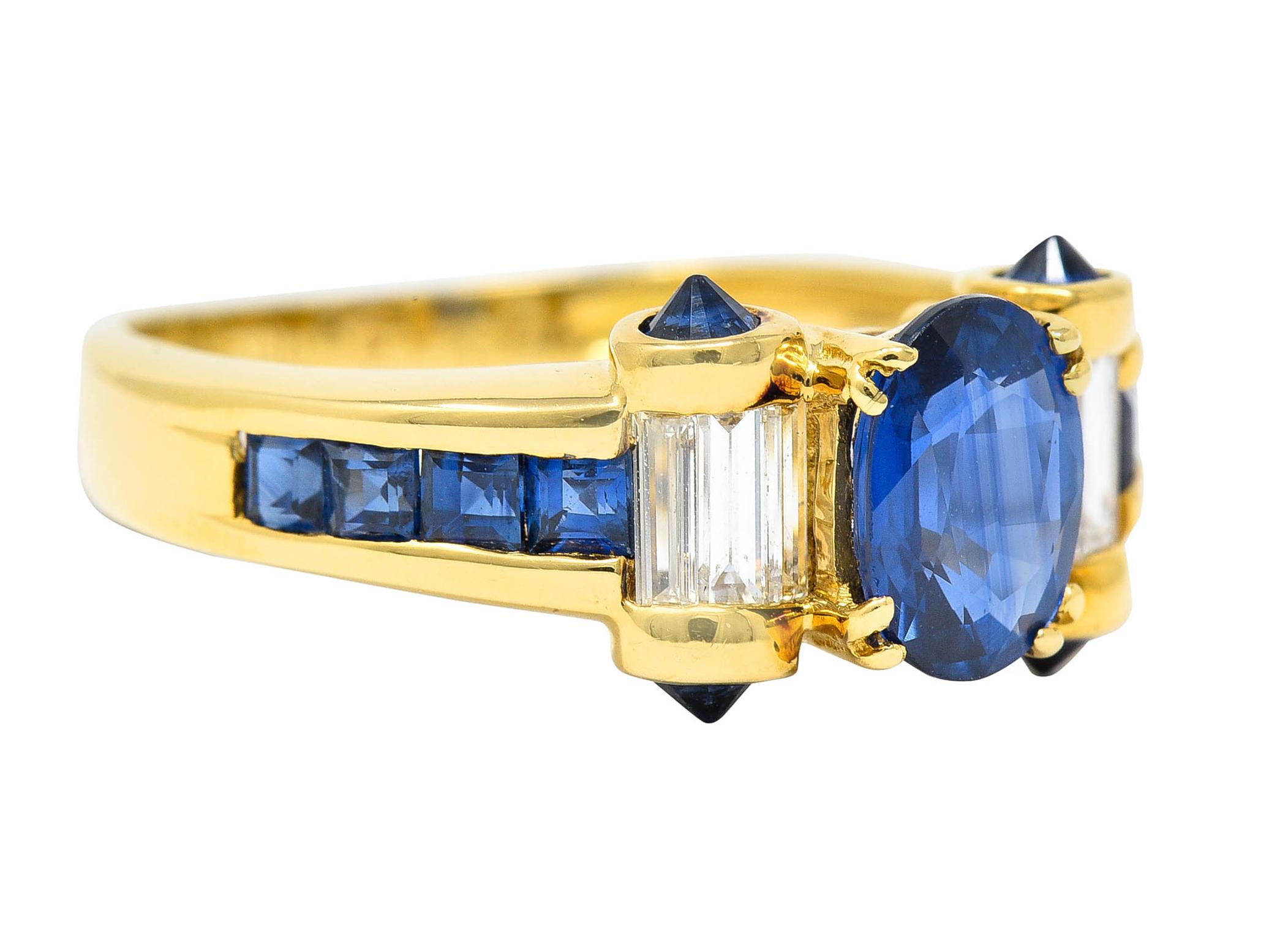 Centering an oval cut sapphire, basket set and weighing approximately 1.10 carats

Transparent and strongly royal blue in color

Flanked by scrolled rotunda shoulders, channel set with baguette cut diamonds, weighing in total 0.56 carat

Accented by