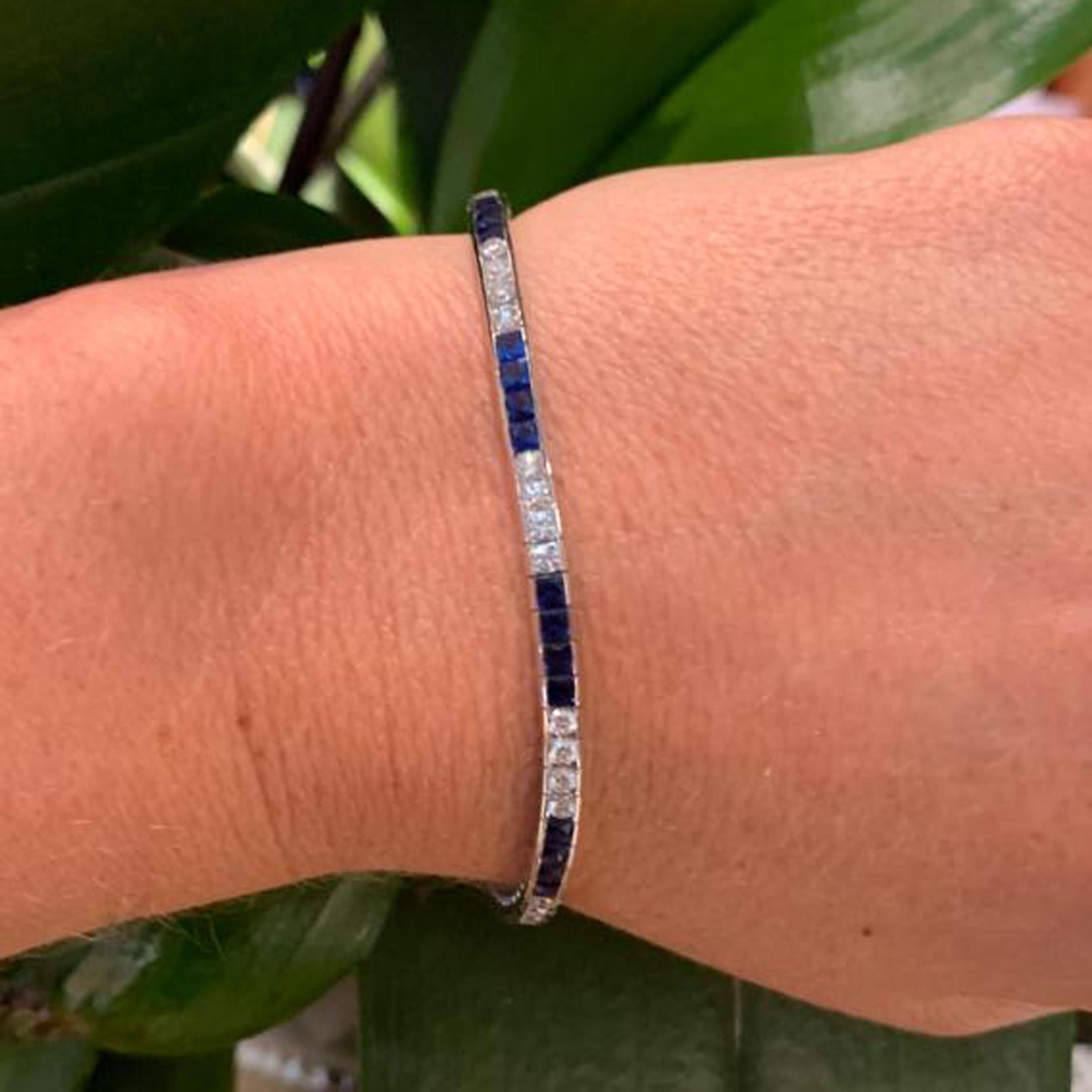 A modern sapphire diamond and platinum line bracelet, set with nine sets of four French-cut sapphires, with a total weight of 3.89 carats and nine sets of four round brilliant-cut diamonds, with a total weight of 1.65 carats, in channel settings,