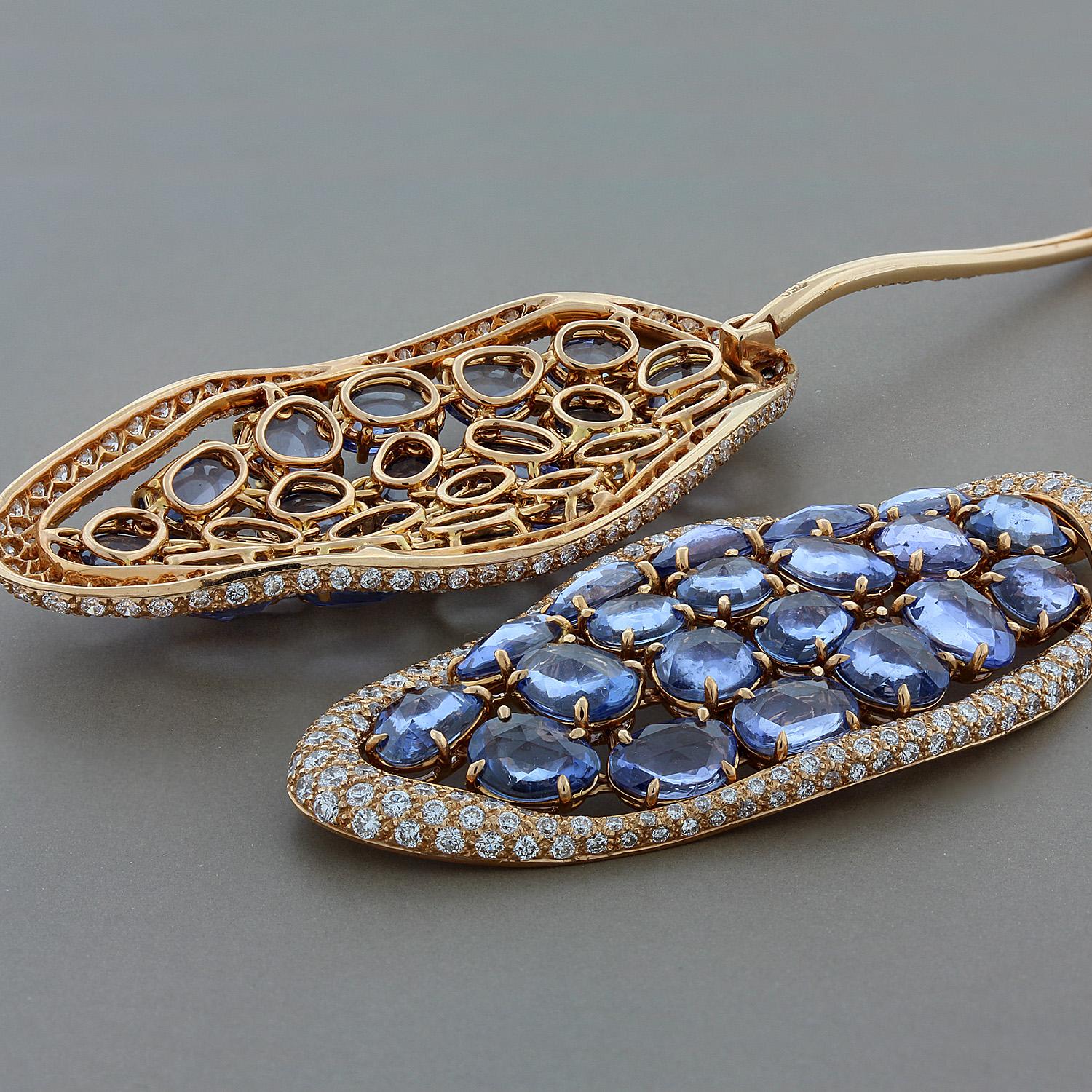 A spectacular styled and crafted pair of designer earrings. They feature 19.71 carats of rose cut blue sapphire which are prong set in 18K rose gold. There are 3.42 carats of round cut white diamond that are set around the blue sapphire and along
