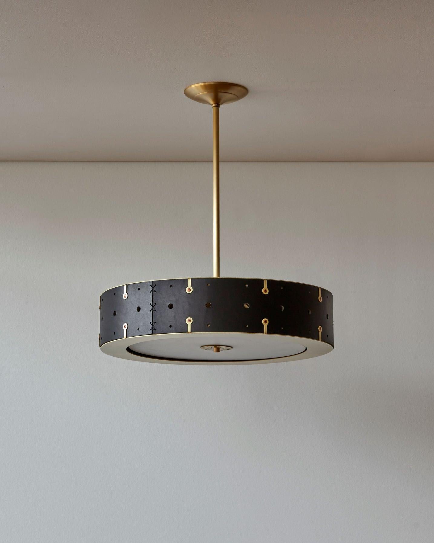 Composed of a hand-sewn leather drum fitted between a satin brass top and bottom ring, the Sarah can be customized with the drop height that is right for your space and the pipe can be removed altogether to create a flush-mount fixture. A thin white