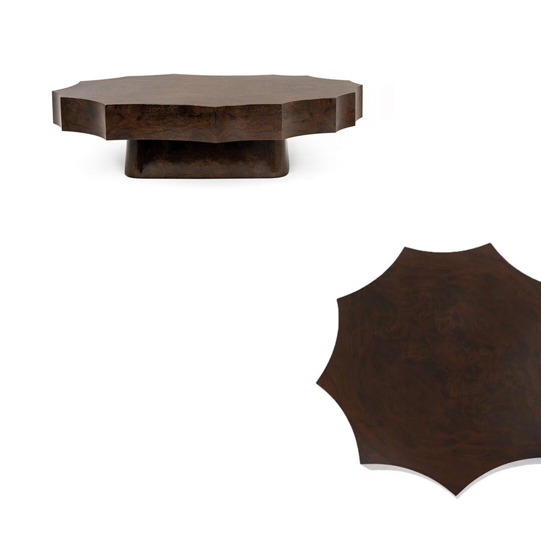 This luxurious round side table is a masterful blend of rich materiality and sophisticated design. It is crafted from stunning walnut root wood, a material prized for its unique, intricate grain that creates a sense of unparalleled opulence. The