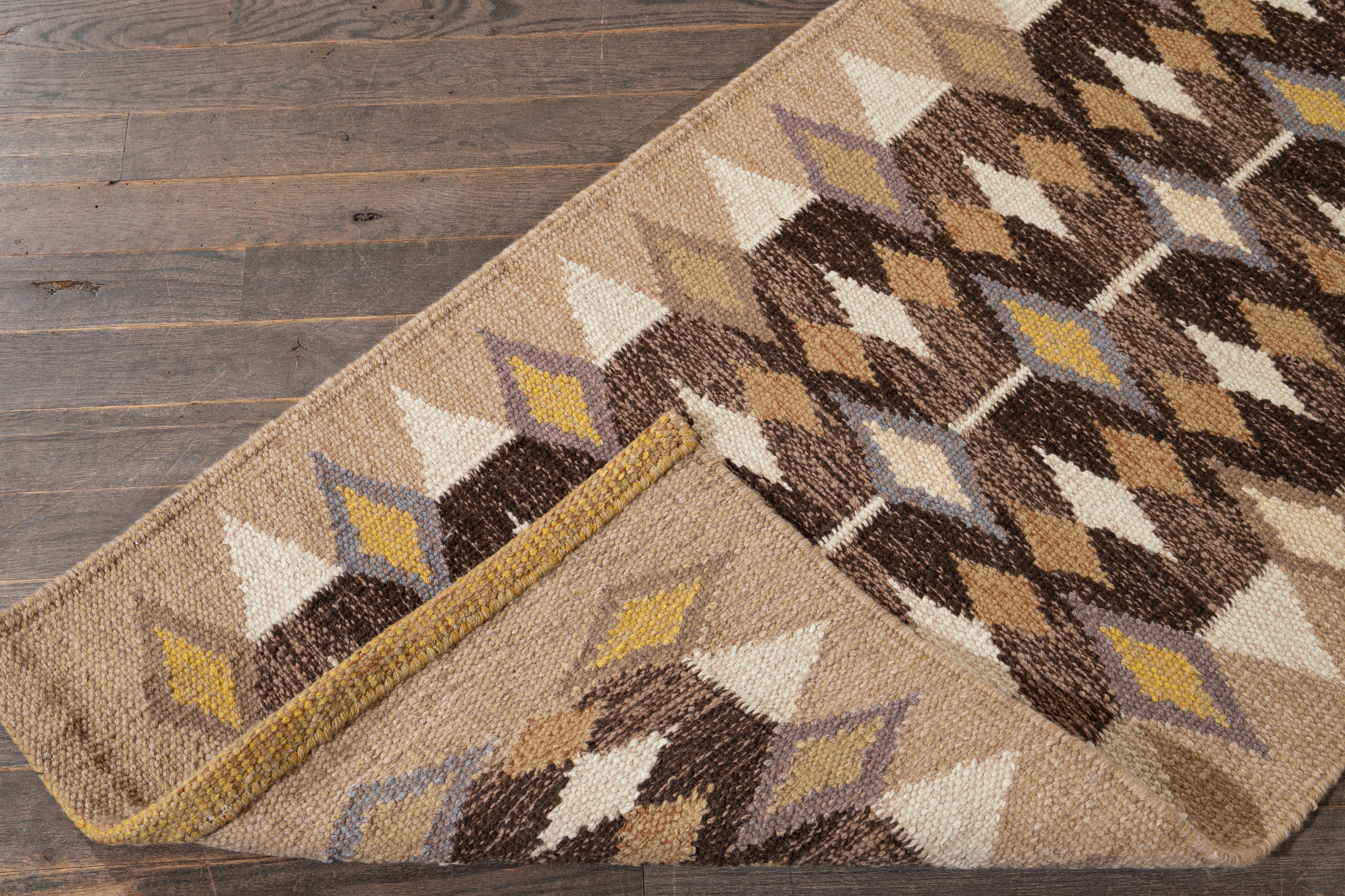 Ti presentiamo un moderno tappeto runner a trama piatta in stile scandinavo, caratterizzato da un ricco campo marrone ornato da accenti tan, gialli, grigi e avorio. Questo tappeto presenta un intricato disegno geometrico all-over che aggiunge un