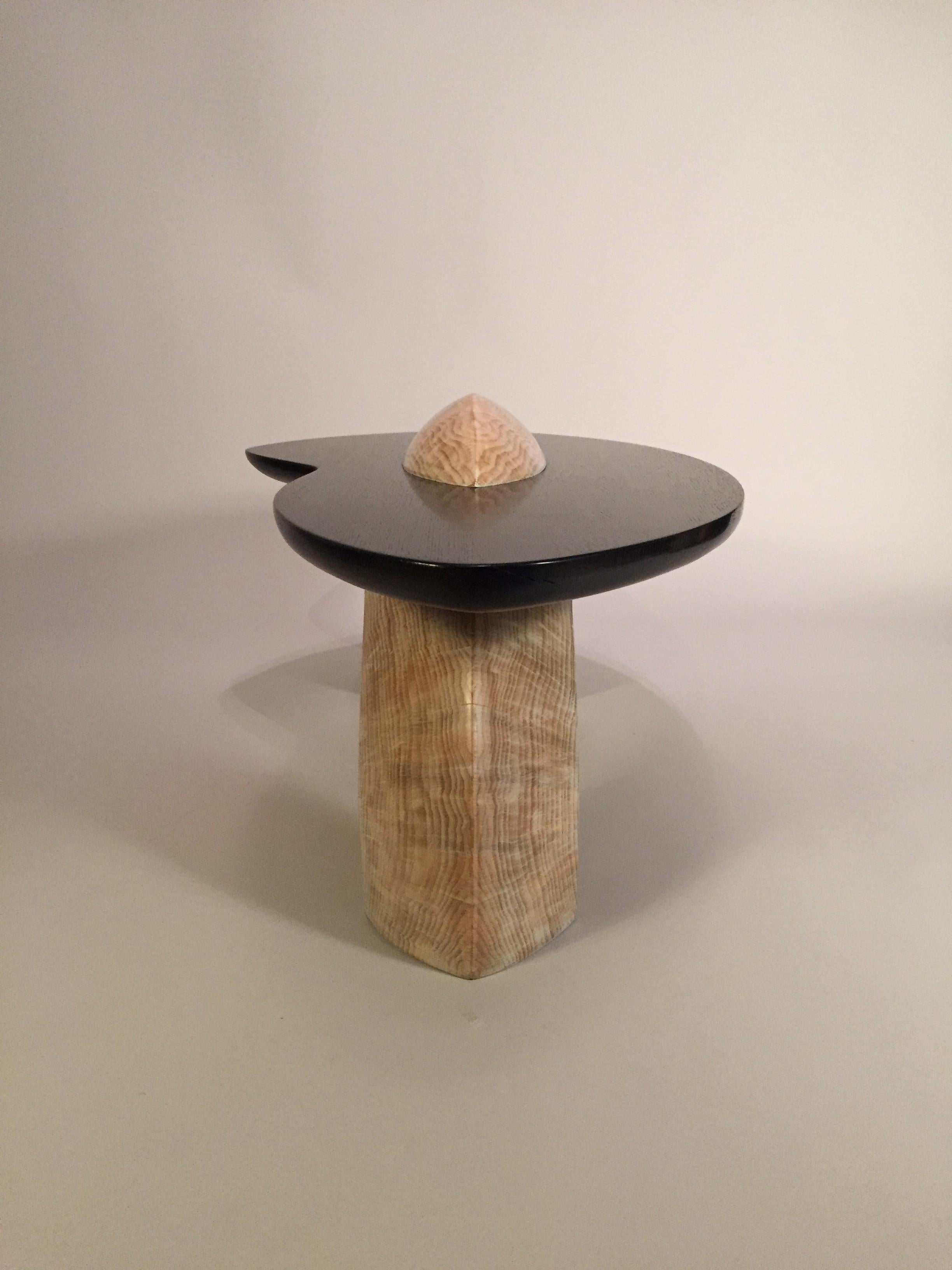 Handcrafted by Gabriel M.

Raw elements of its origin resonate through the aesthetic of this piece. Atop a sculpted 4ft diameter tree trunk of pine wood sits a plain of blackened oak, which celebrates the harmony between the human touch and the