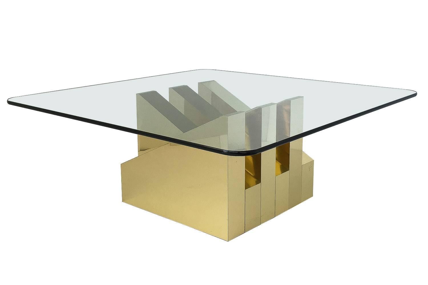 Modern and sculptural brass clad coffee table, circa 1970s. Mirror polished brass clad square base with six triangular forms. Geometric and abstract in form. Base measures 20