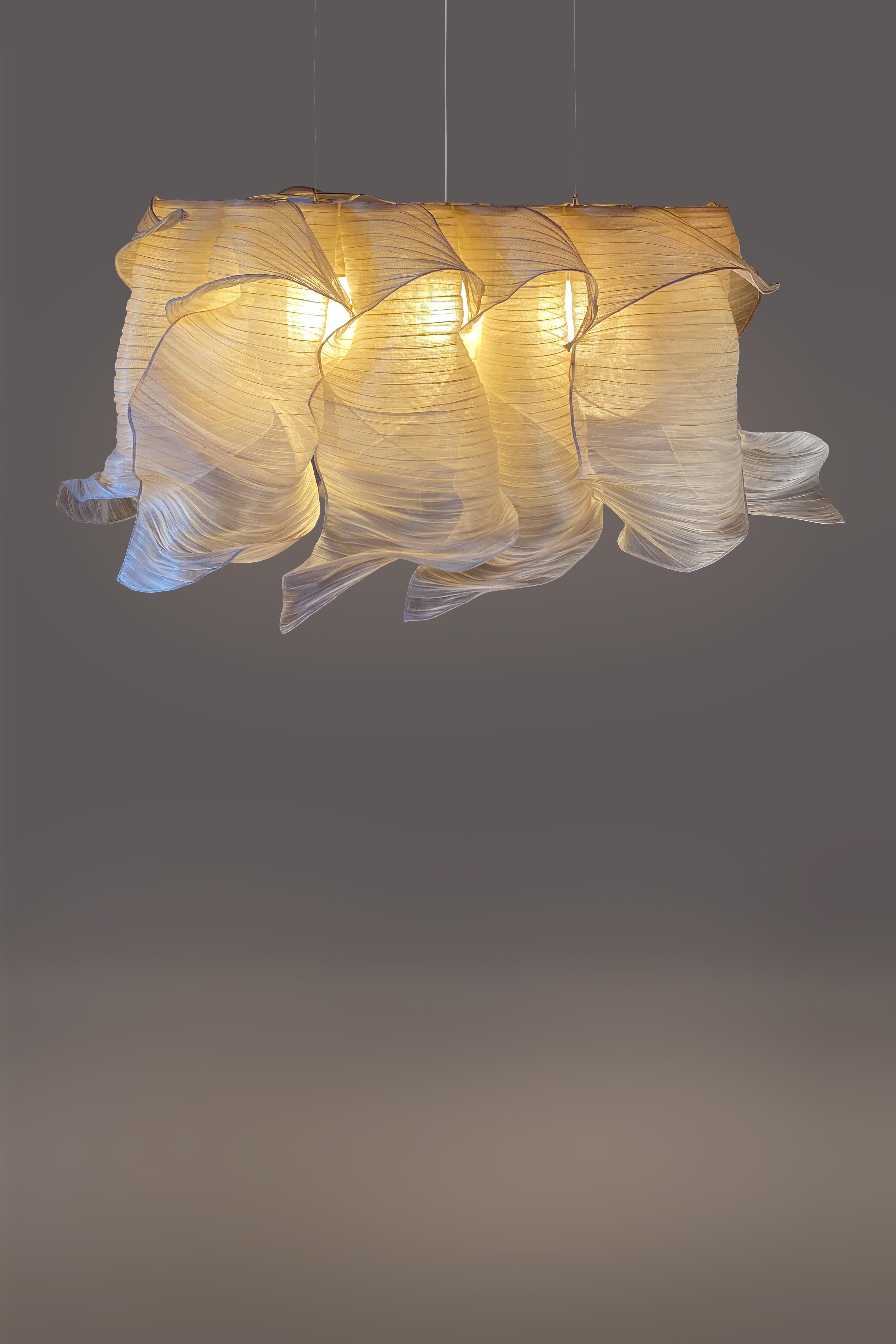 Providing soft light in an organic and unique design, the Nebula Pendant Chandelier draws its inspiration from the interstellar clouds of dust and gas. Entirely handcrafted of Banaca (banana-abaca), a fiber from the Philippines woven by a community