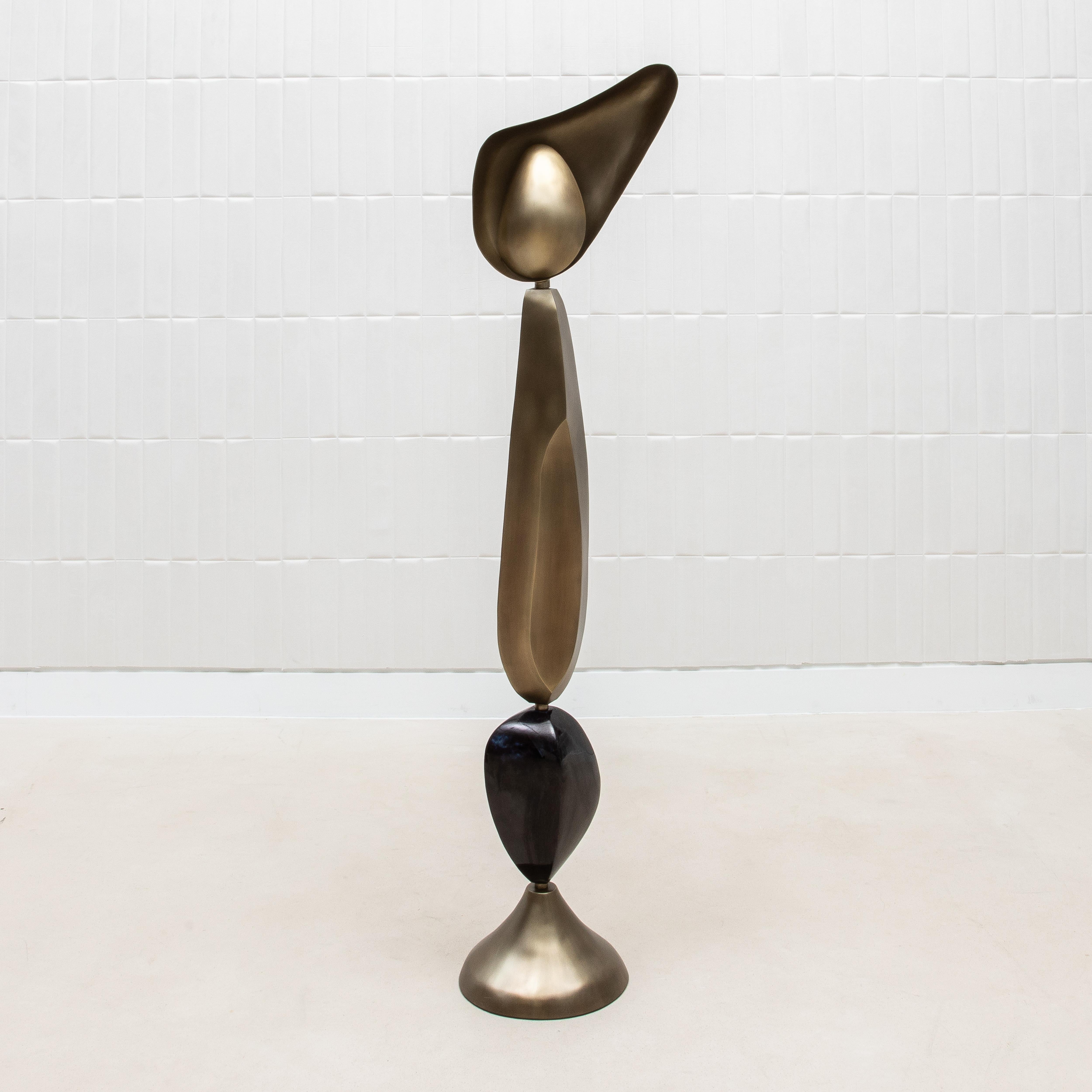 The Cosmo Moon Floor Lamp by KIFU Paris is a stunning piece of functional art, expertly handcrafted to embody timeless luxury and modern design. Its bold silhouette features a harmonious combination of bronze patina brass and black shell, creating a