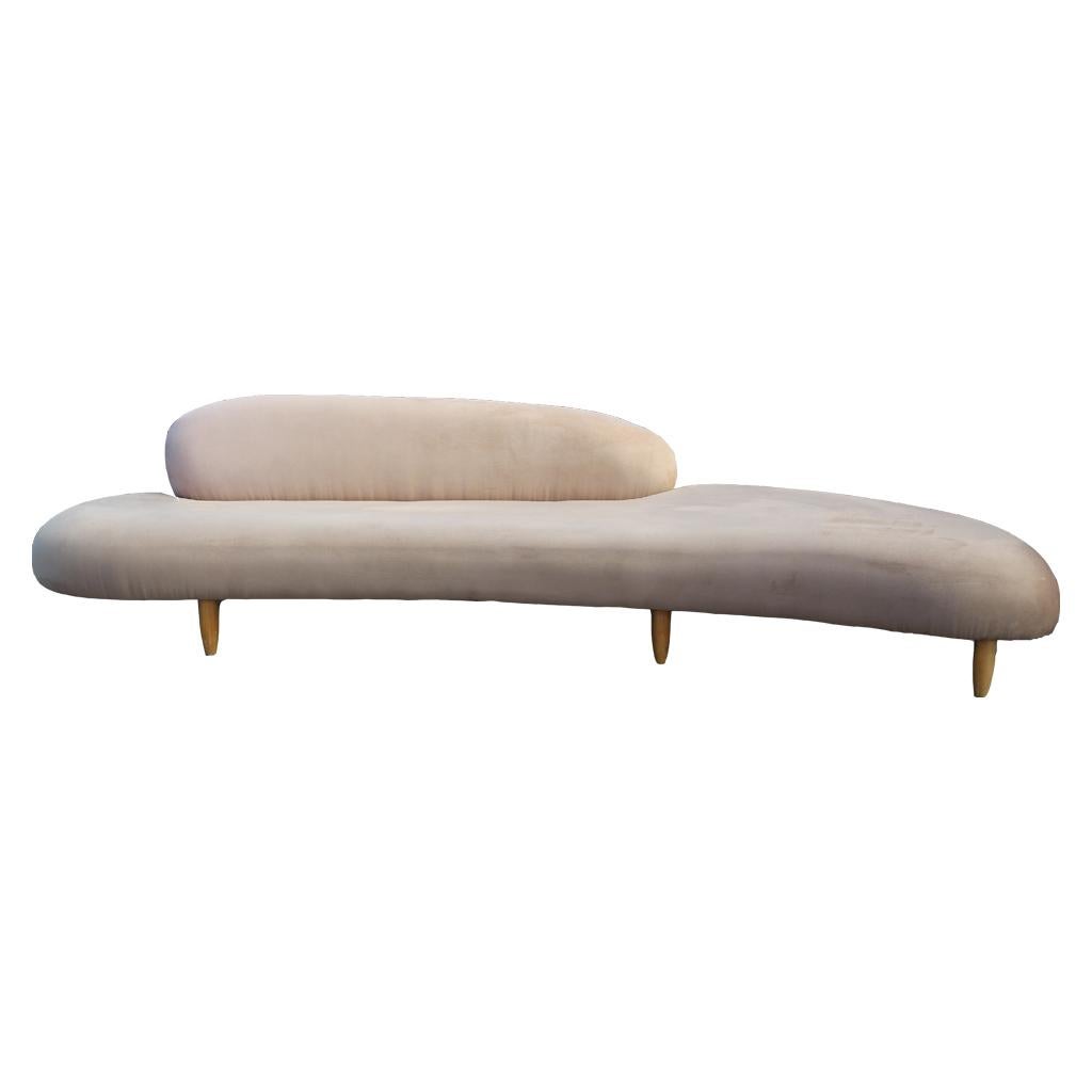 Sculptural freeform cloud sofa and ottoman by Isamu Noguchi for Virta. The velvet is a light pink color with walnut legs. 
Ottoman measurements: H 16 in. x W 45.5 in. x D 26 in.