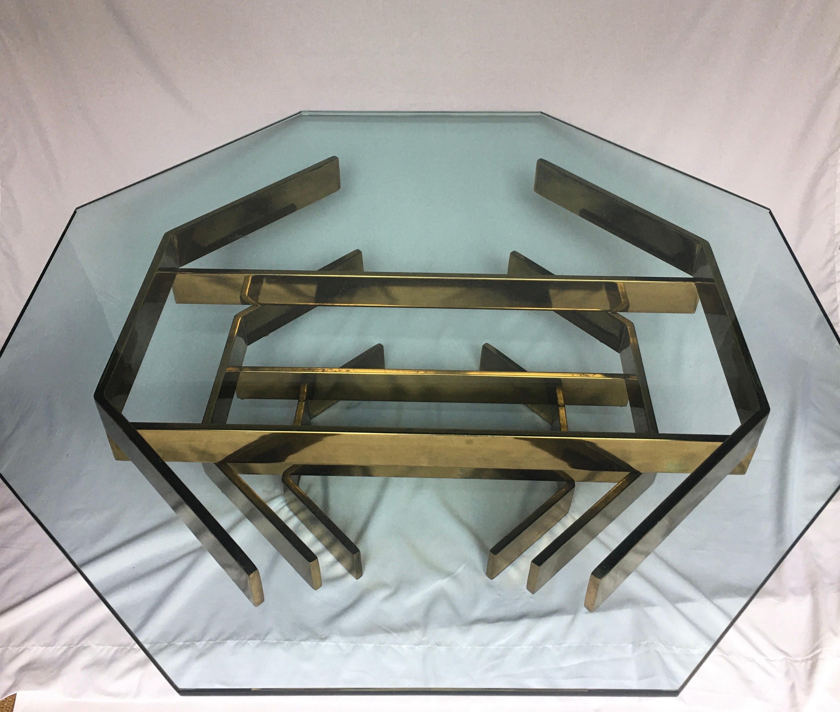 Mid-Century Modern sculptural coffee table in the style of Paul Mayen and Milo Baughman.  Stunning gold brass plated metal base features interlocking stacked cityscape like flat bar stretchers which support a removable .75 inch thick octagon shaped