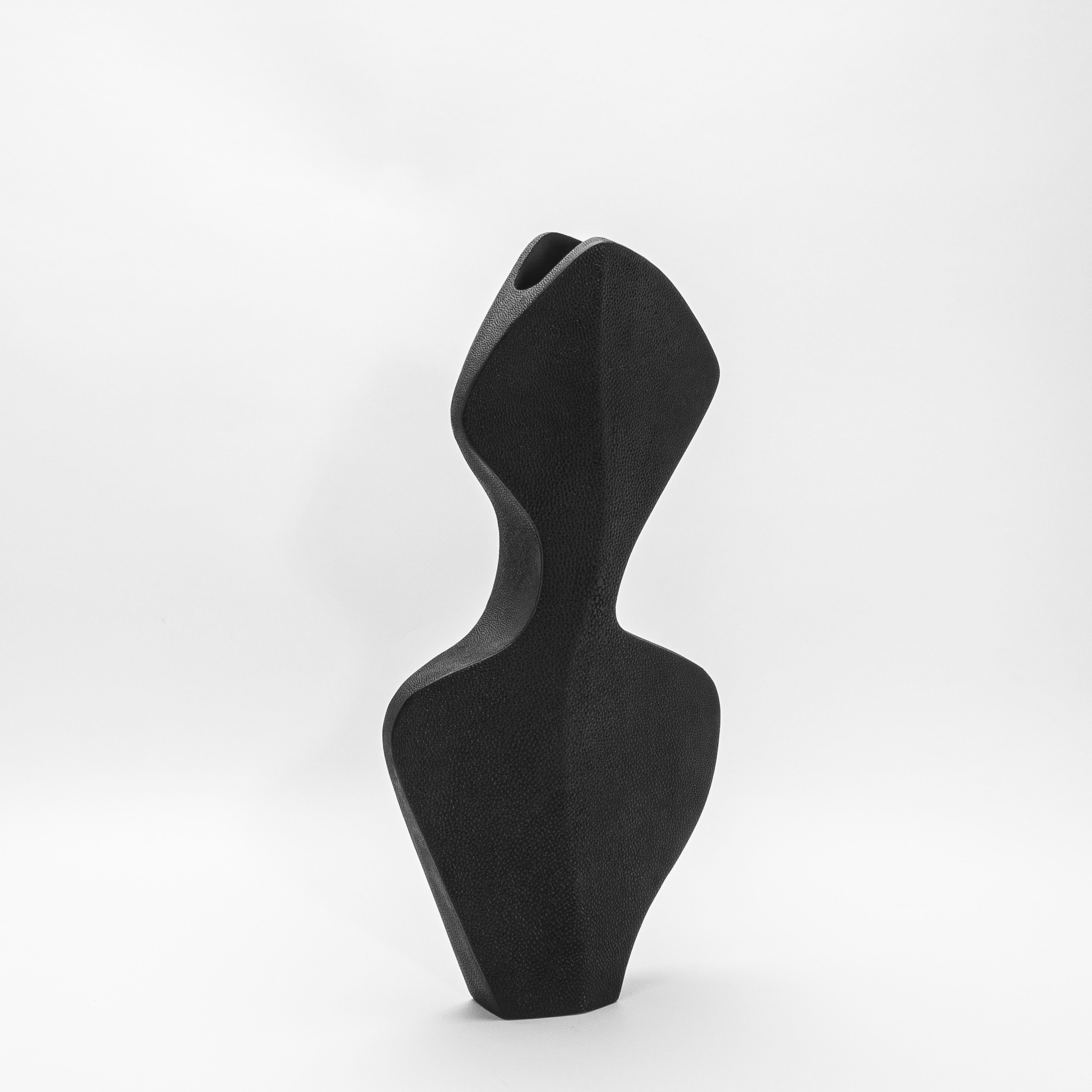 The La Dame Vase by R&Y Augousti is a striking embodiment of modern elegance and refined craftsmanship. Its sculptural form is wrapped in luxurious black shagreen, lending the vase a rich, textured finish that feels both timeless and contemporary.