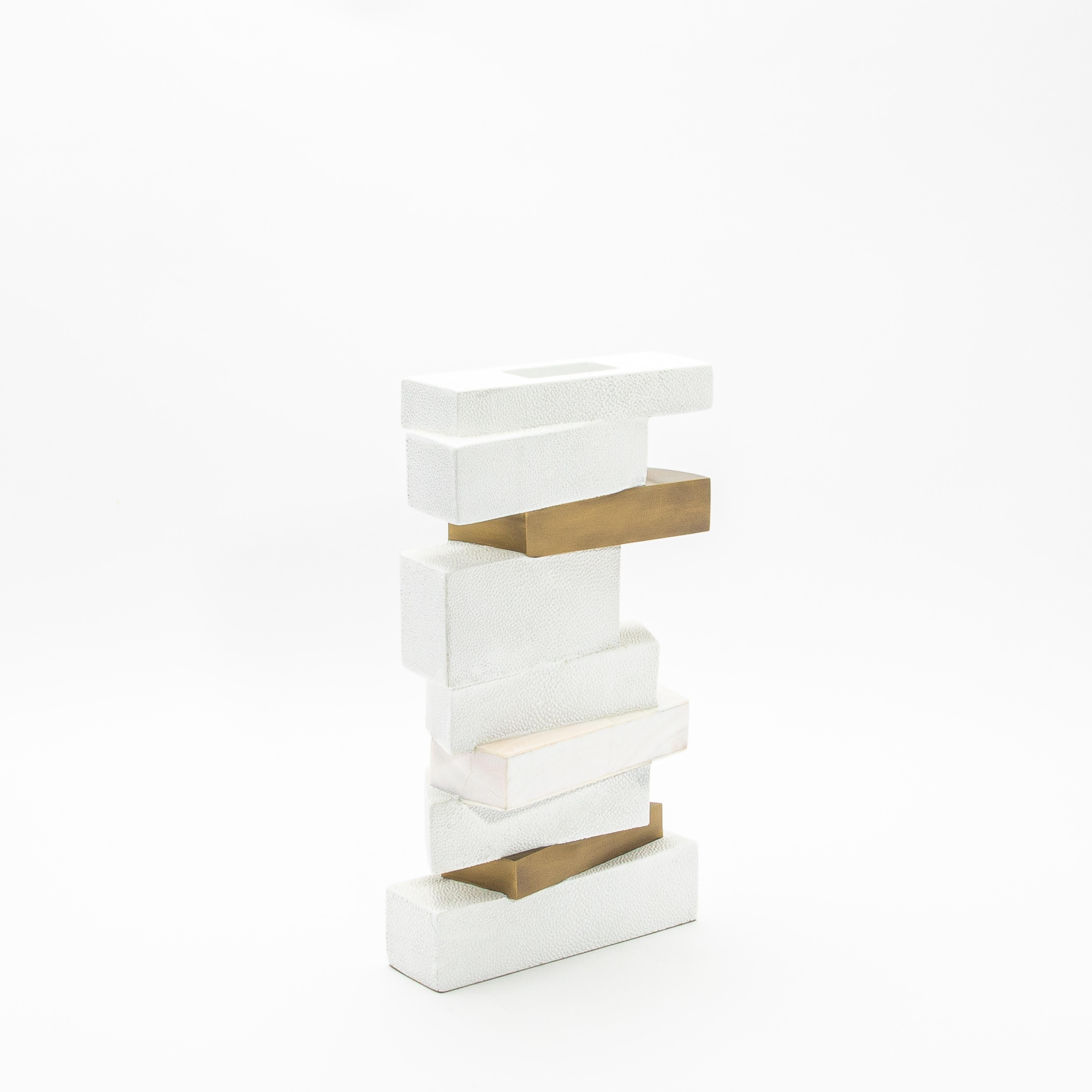 The Bullion Confection vase by Kifu Paris is a striking example of contemporary artistry, blending architectural design with luxurious materials. This sculptural piece showcases layers of meticulously handcrafted white shagreen, elegantly contrasted