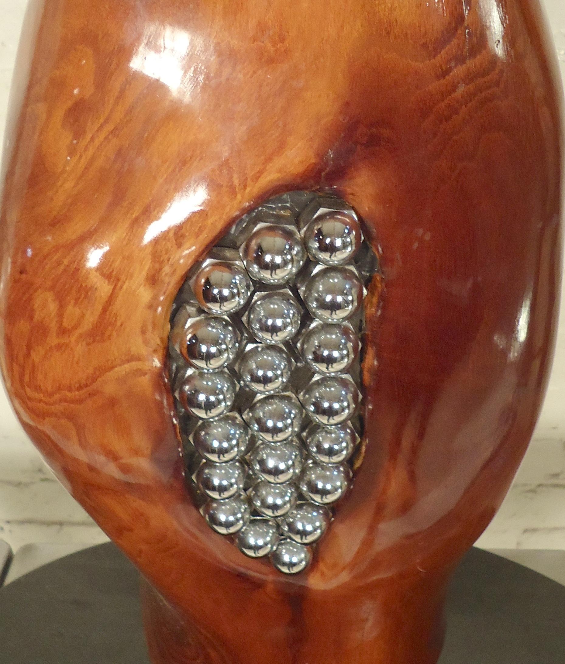 Unusual handmade sculpture art featuring a polished tree slab with inlaid lug nuts, set on a marble base.

(Please confirm item location - NY or NJ - with dealer).
 
