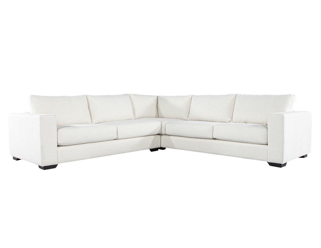 Indulge in unparalleled comfort and sophisticated design with this modern sectional sofa by Carrocel. Expertly crafted in Canada, this statement piece boasts a solid maple wood frame, ensuring lasting durability. Upholstered in a luxurious cream