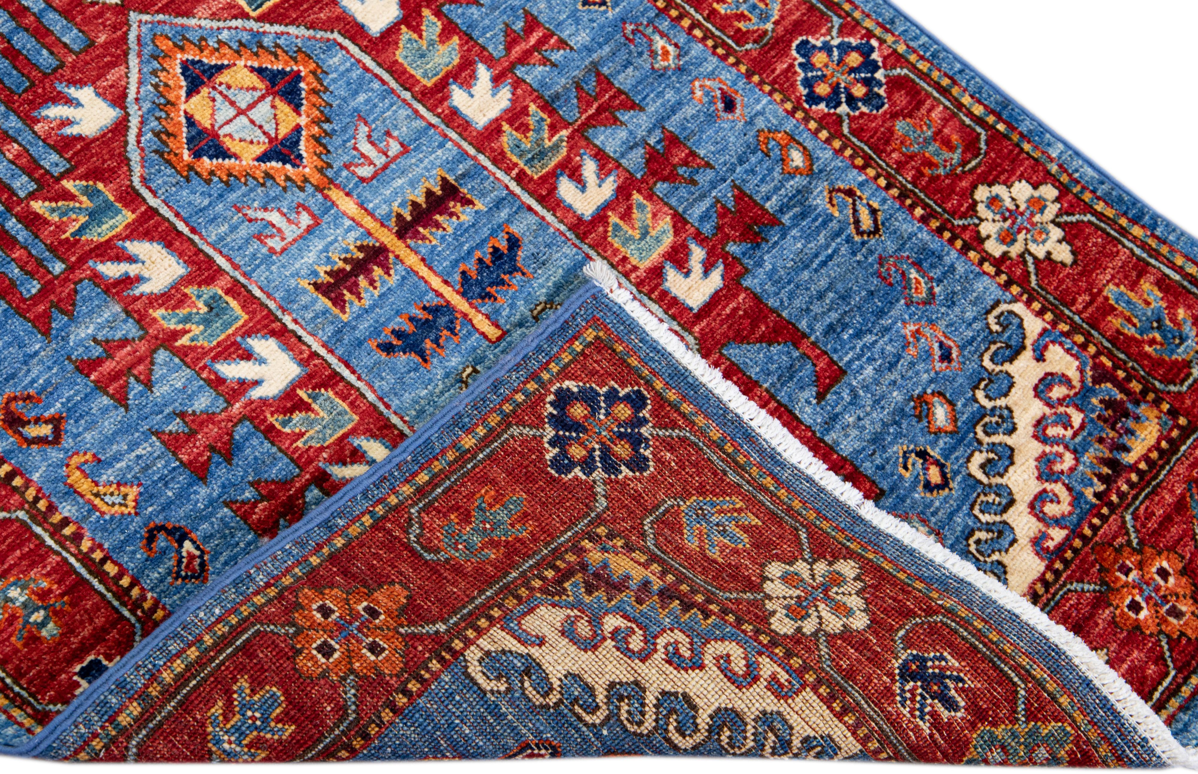 Beautiful antique Serapi style hand-knotted wool runner with a blue field. This piece has a red-designed frame and an all-over gorgeous floral design with multicolor accents.

This rug measures 2'8