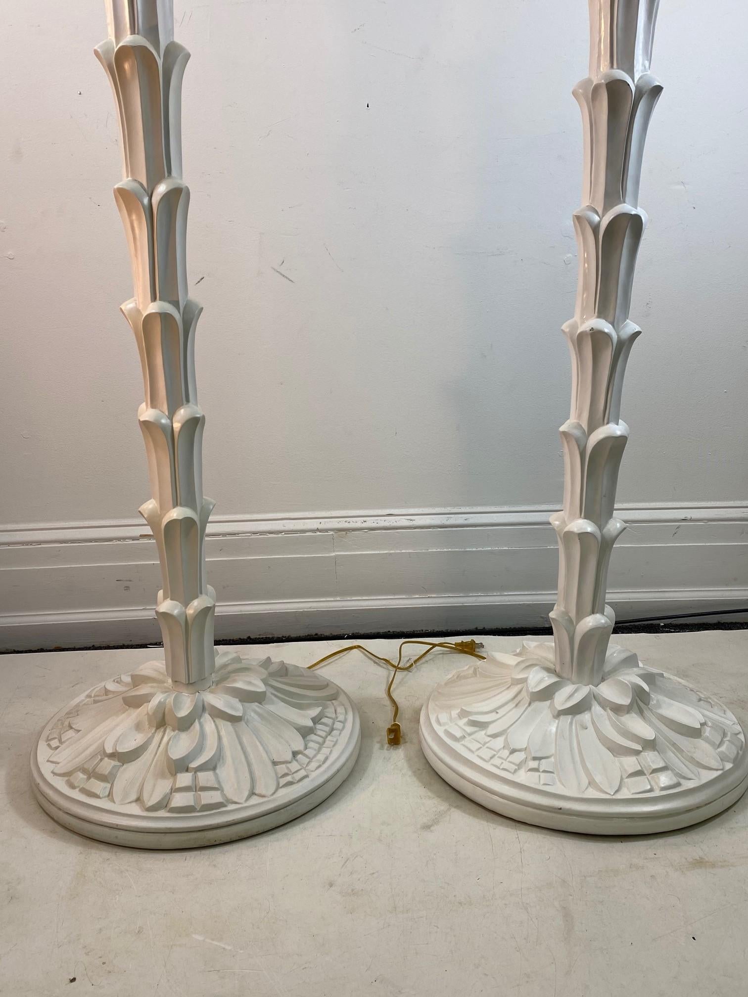 French Modern torchère floor lamps in the style of Serge Roche. The pair is handmade of carved and painted wood and was made in the early 21st century. In great vintage condition with age-appropriate wear and use.