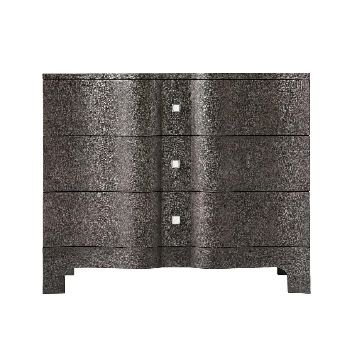 Modern Serpentine Leather Wrapped Nightstand with a shagreen embossed leather in our dark tempest finish, with polished nickel hardware and raised on bracket feet.

A wonderful modern interpretation of a Rococo Chippendale design from the 18th