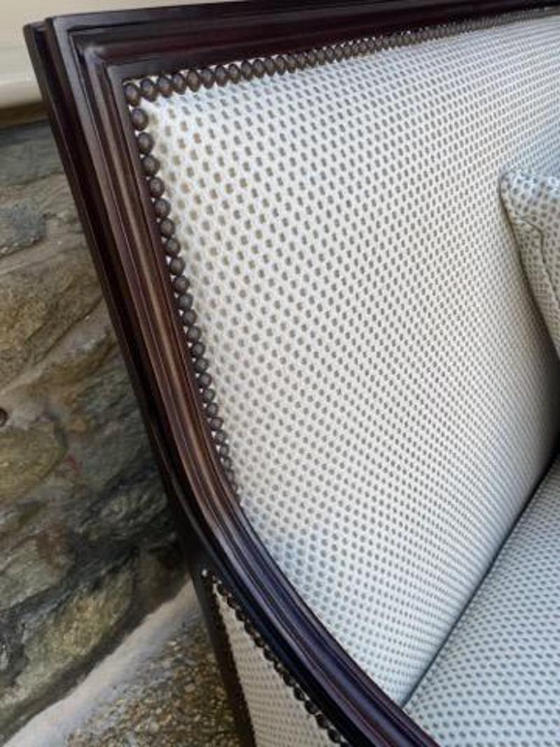 Modern Settee with Cream & Tan Textured Upholstery and Dark Wood by Sheffield Furniture and Interiors. Carved details on arms and nailhead accents add to the overall beautiful design. Includes two matching pillows (as pictured). Measures: 39