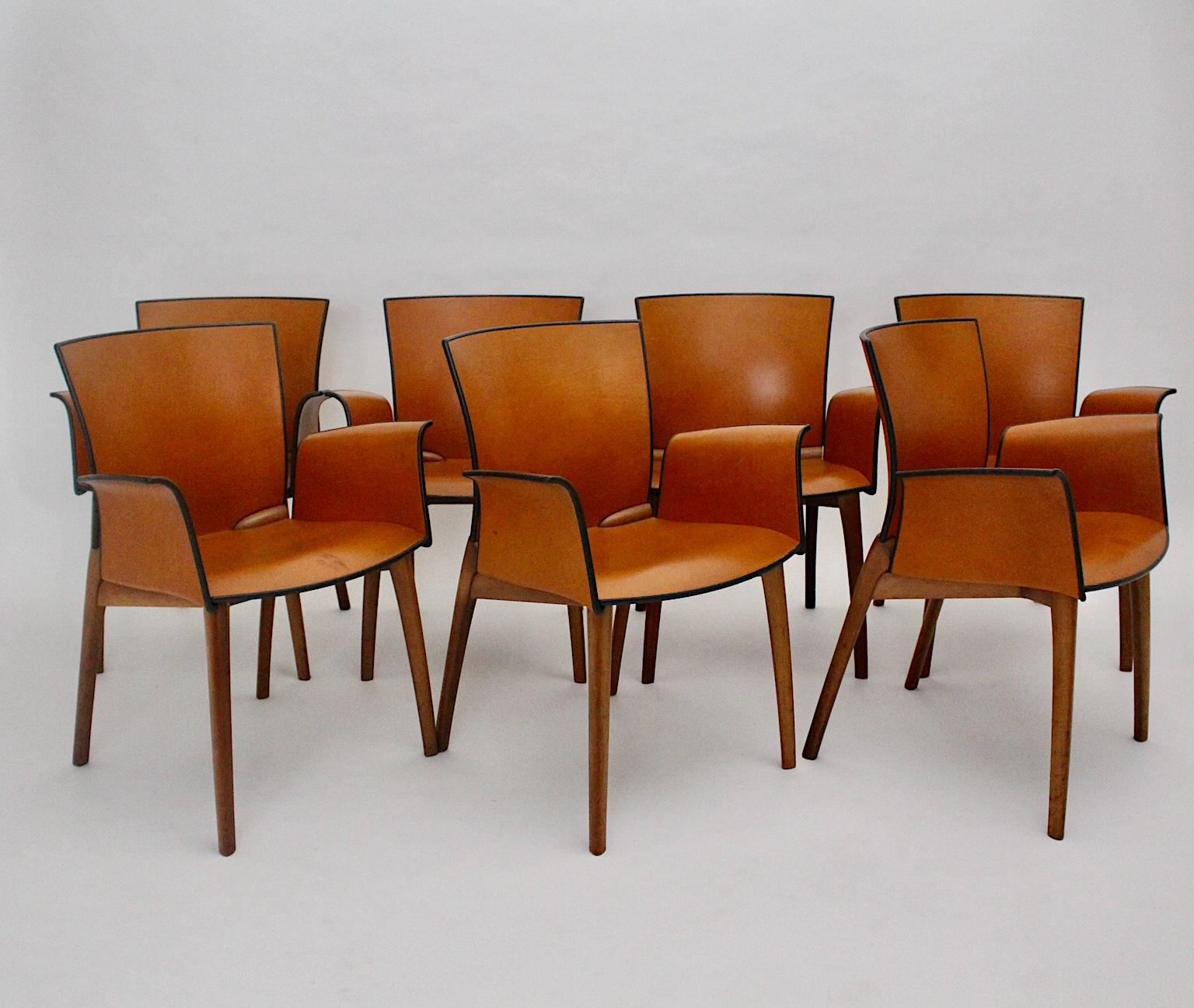 Modern set of 7 vintage dining chairs, which were made out of a wooden base and cognac brown leather armchair shell.
Stamped Cassina - N 10
The set of dining chairs by Josep Lluska feature a beautiful curved seat shell. The armrests flow into the