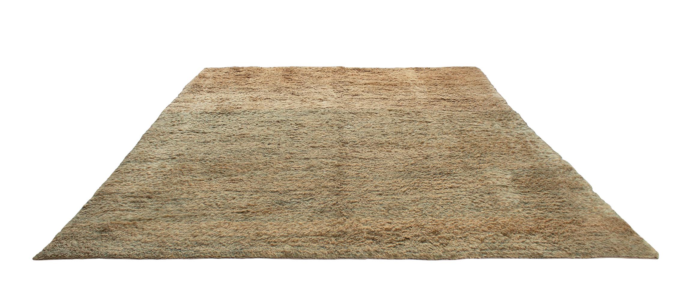 This shag rug is made with 100% handspun Persian wool with natural dyes. It is inspired by the vintage rugs that are native to the Shiraz region in Iran. Nasiri continues their rich tradition of rug making by applying the same techniques and methods