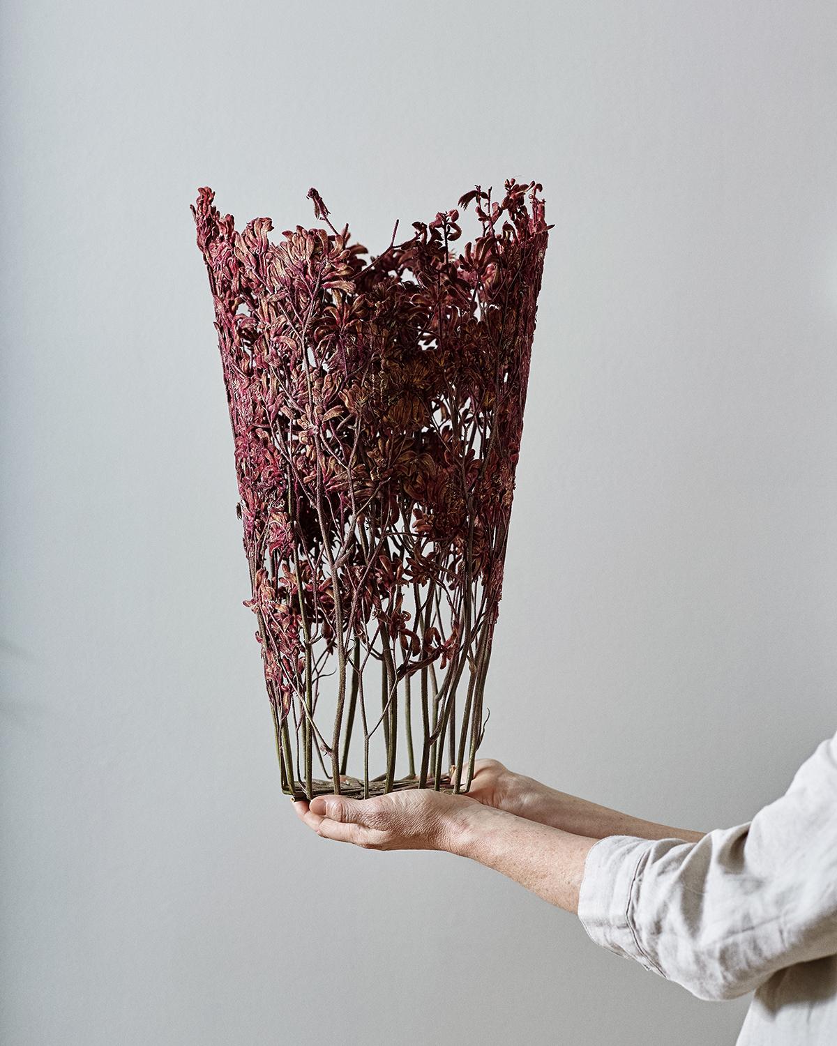Hand made vase created with sun dried flowers, acquired locally at the London market, city of its author. The select flowers are thus always unique: after a drying process of two months the flowers are woven together and then treated with a vegetal