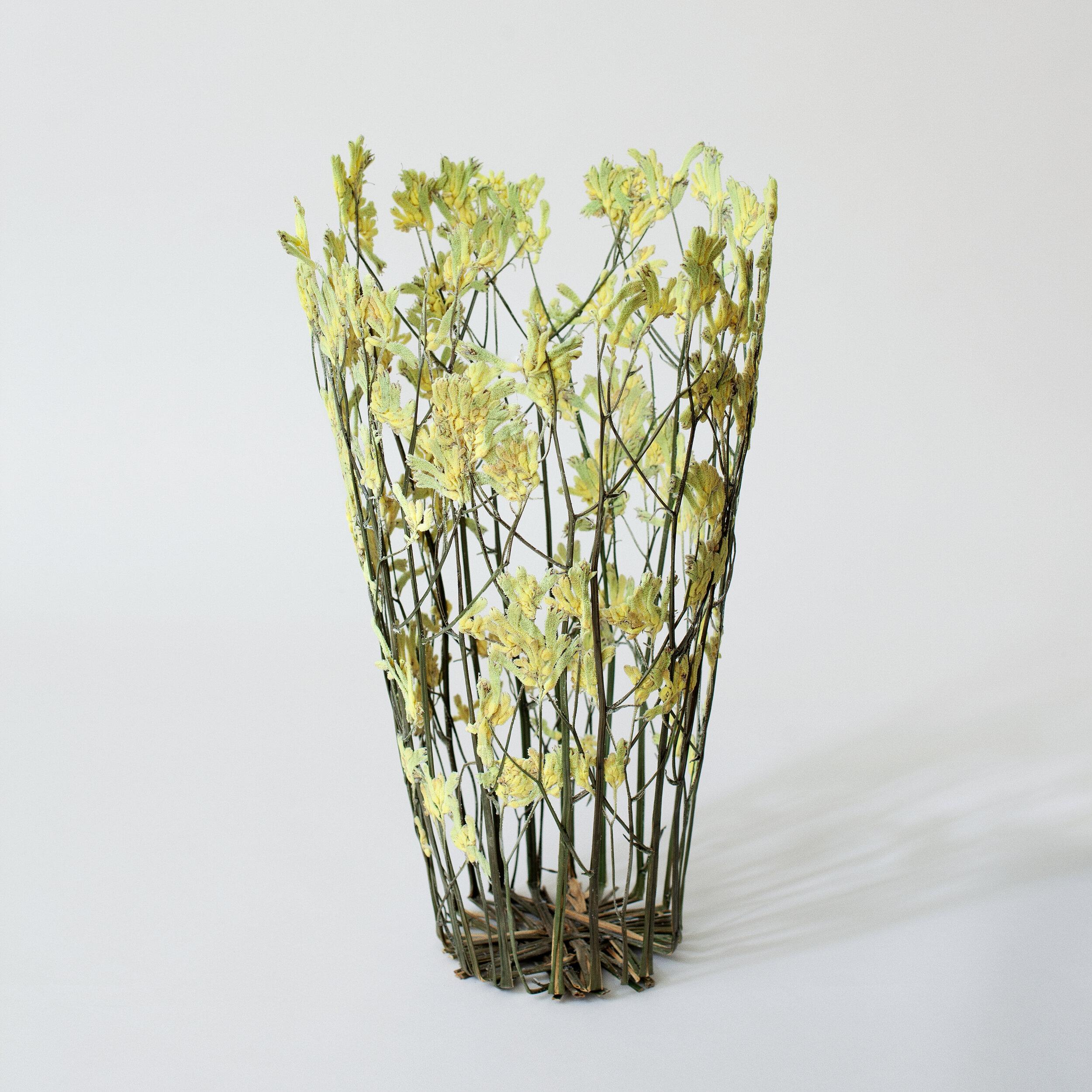Hand made vase created with sun dried flowers, acquired locally at the London market, city of its author. The select flowers are thus always unique: after a drying process of two months the flowers are woven together and then treated with a vegetal