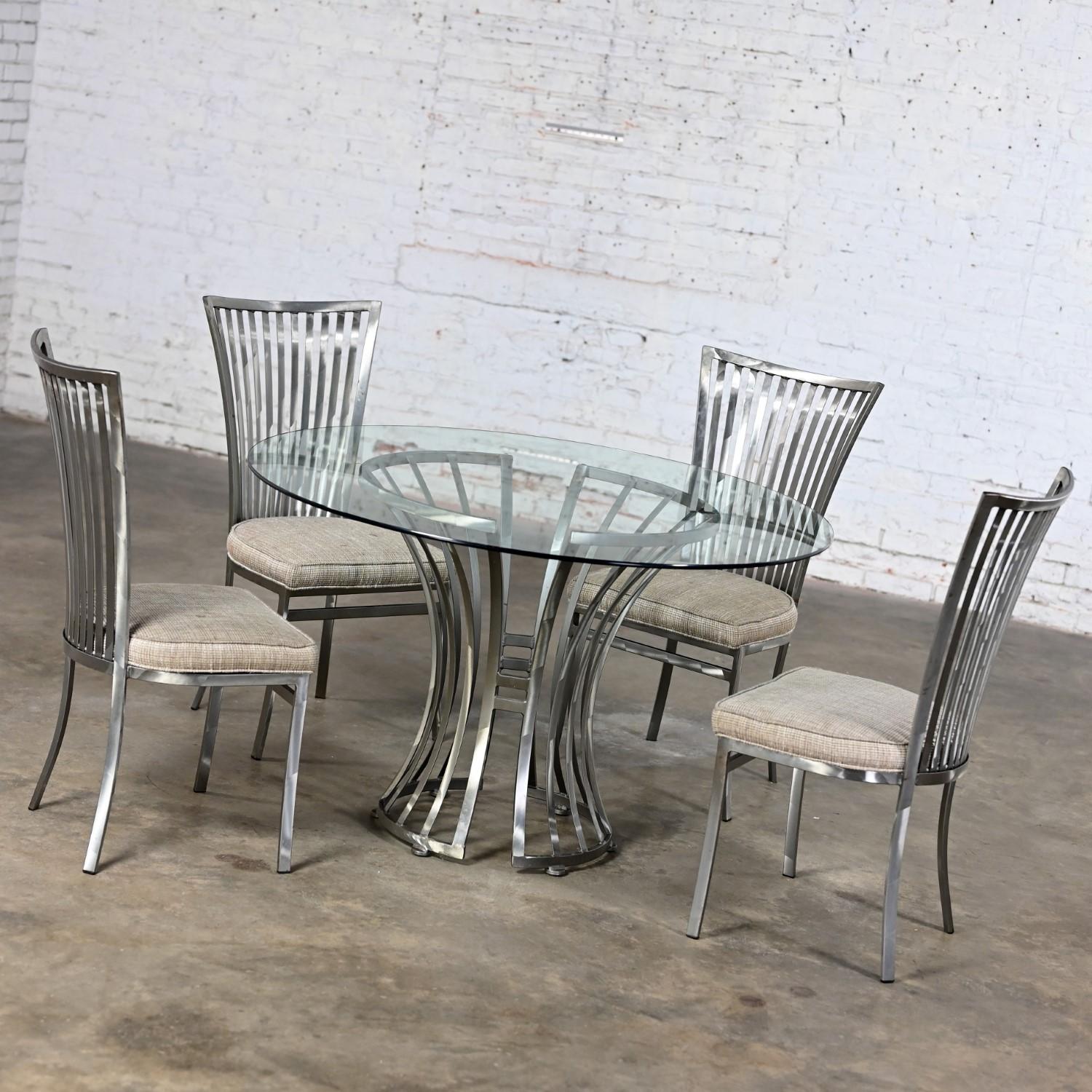 Marvelous vintage Modern Shaver Howard dining set slatted steel tulip pedestal base table with a round glass top and four slatted steel frame chairs with greige tweed seat cushions. Beautiful condition, keeping in mind that this is vintage and not