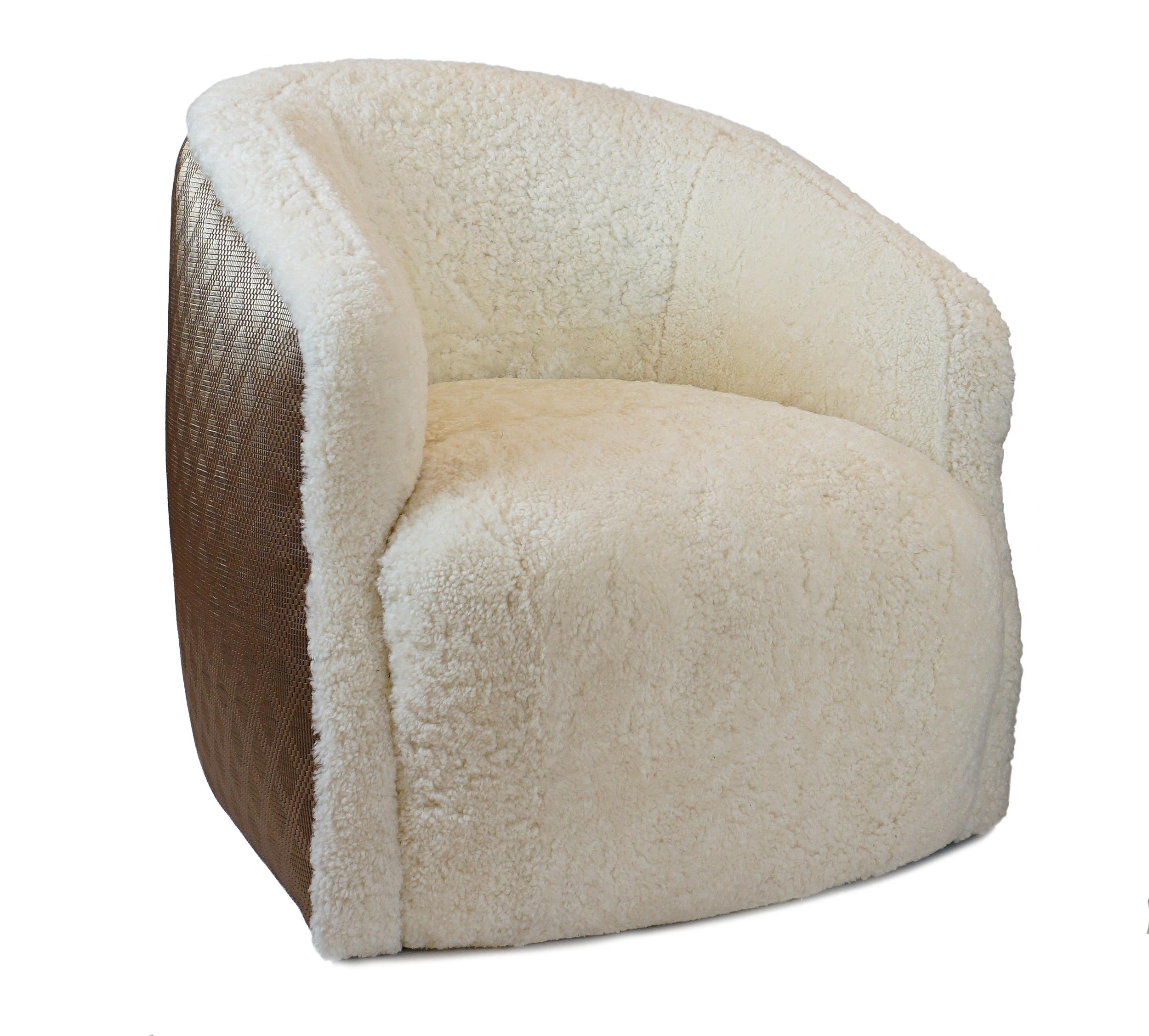 Slope arm bucket swivel chair with real shearling and contrast vinyl on outside back. Tight, firm, responsive seat and upholstery. Swivels 360 degrees. 

Measurements:
Overall: 33”W x 34”D x 31”H
Inside: 19”W x 22”D x 14”H
Seat height: 18