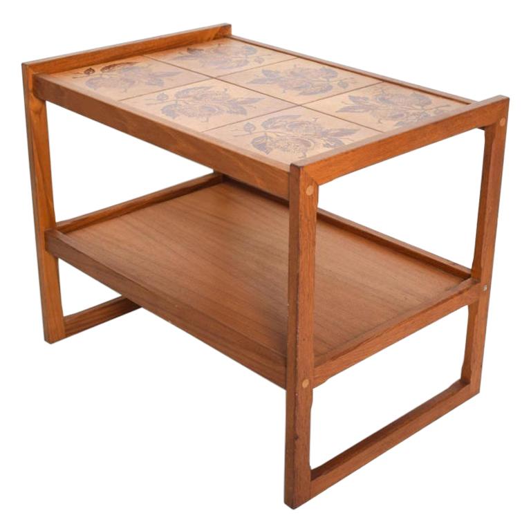 Service Table
Scandinavian Modern teak table bar cart service with ceramic tile tabletop inset into teak wood.
Stamped MADE IN DENMARK attribution OX Art 1979
This modern tiled cart is useful as a bakery bar or kitchen side table service.
Convenient