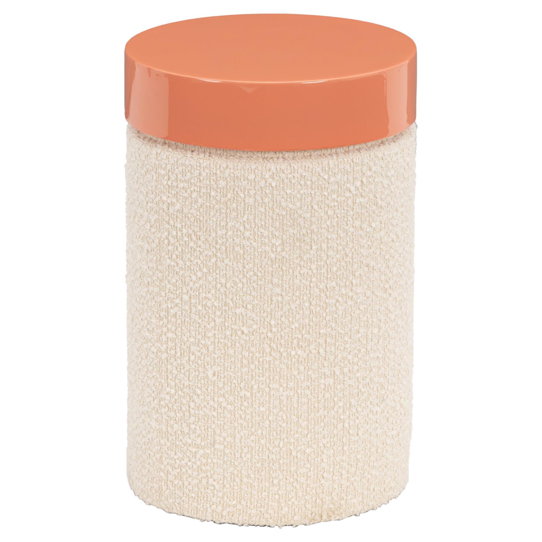 Introducing the KU Side Table, a stunning piece designed by Spazio Bressan that combines functionality with bold aesthetics. This sleek cylindrical table features a beautiful interplay of textures, with its body upholstered in  ivory boucle and