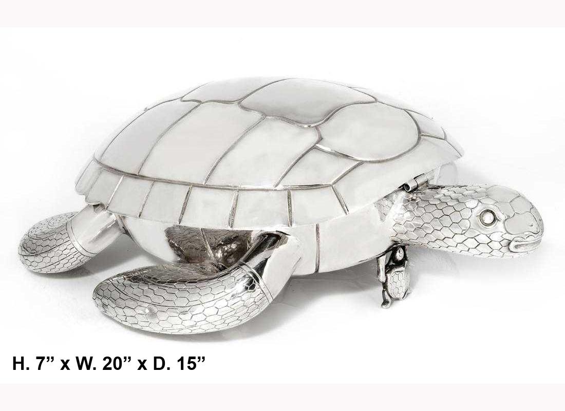 Large silver plated tortoise-form serving platter with beautiful detail, 20th century. Large swimming tortoise is supported by baby tortoise.
The hinged tortoiseshell reveals a large compartment. 

Can be used as a centerpiece or a serving