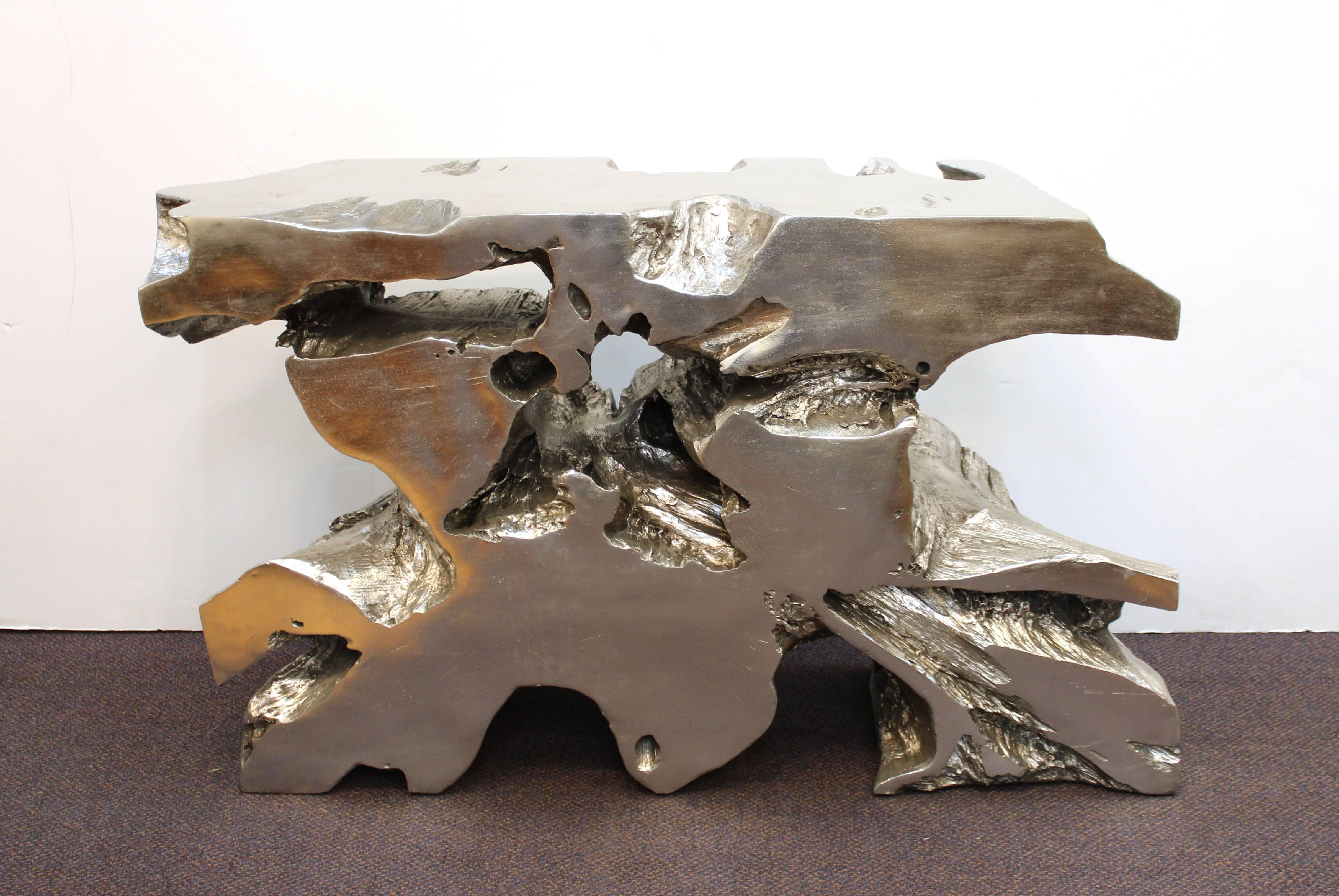 Modern tree trunk console in cast resin with a silvered finish. The piece dates from the late 20th century and was made in the United States. In very good vintage condition with a few minor scratches to the surface.