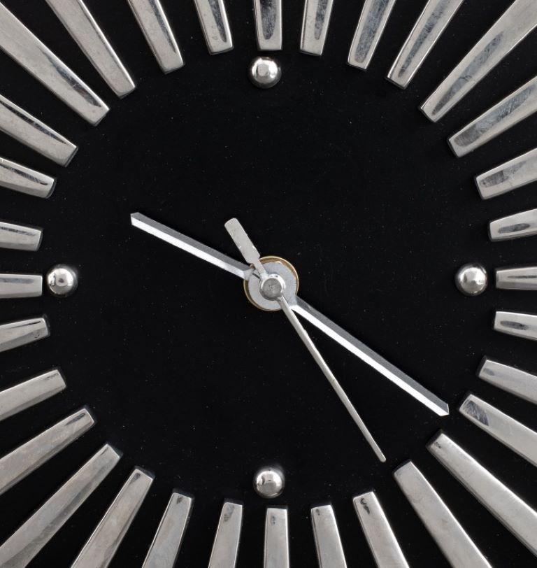 Modern Black and Silvered Metal Analog Mantel Clock on black marble base.

Dealer: S138XX