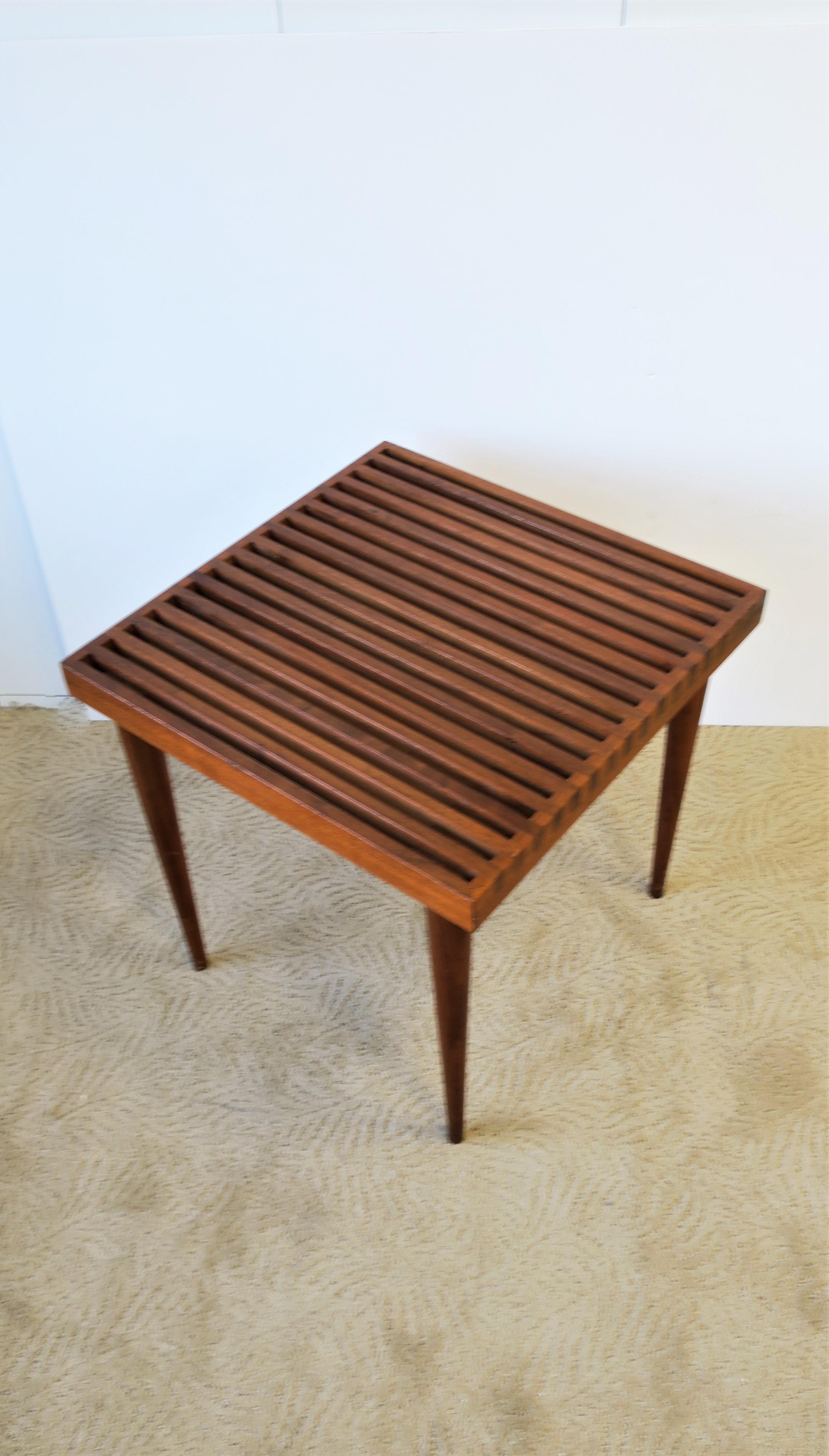A Mid-Century Modern or Scandinavian Modern style slat wood end / side table attributed to American designer Mel Smilow, circa mid-20th century, USA. Table is well made with quality wood, beautiful details, square in shape with tapered legs.
