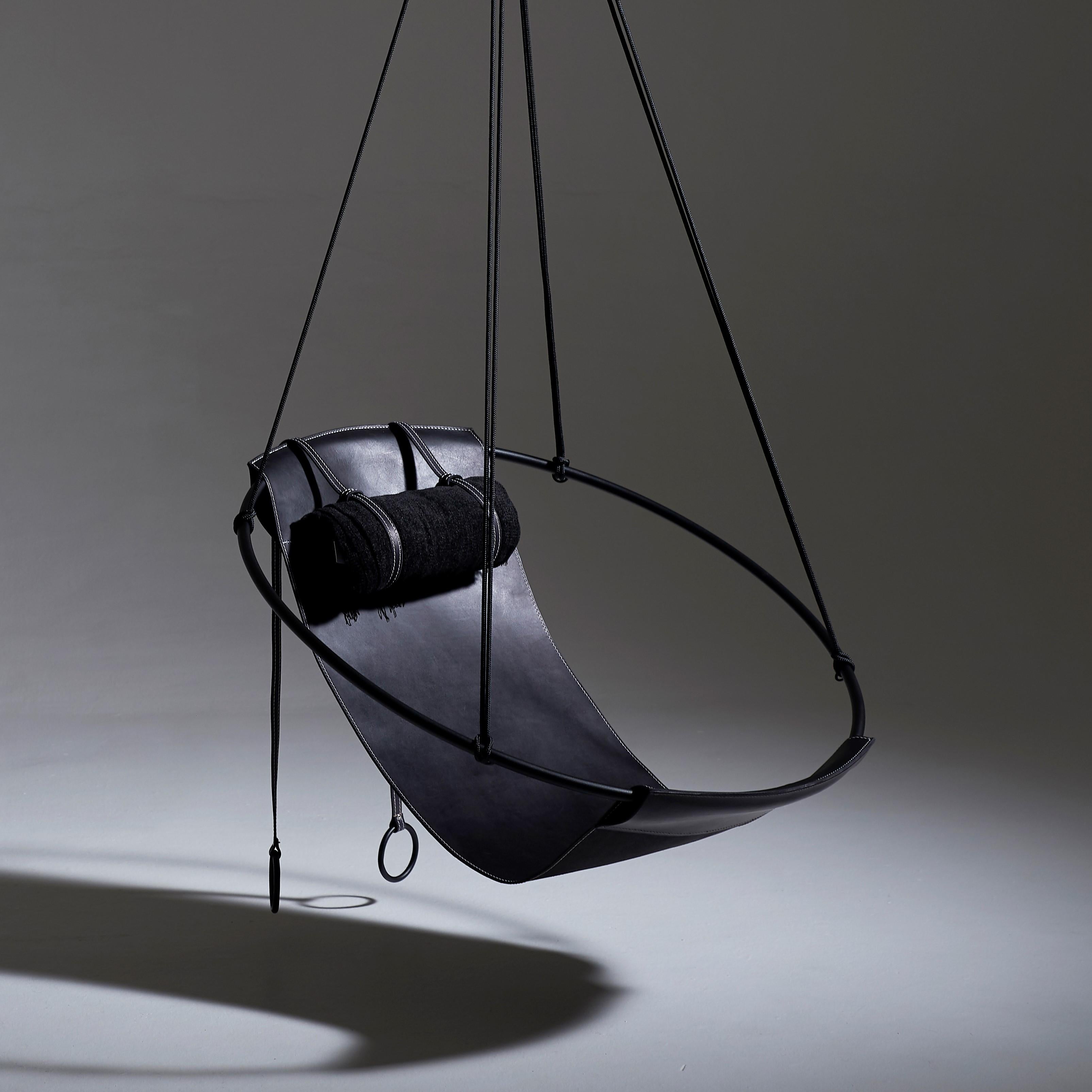 Stripped away from all excess, this hanging chair has a circular frame with a sheet of natural thick leather hanging loose within it, to create a sleek, sexy, and oh so comfortable experience. This chair’s clean lines and lightness makes it a