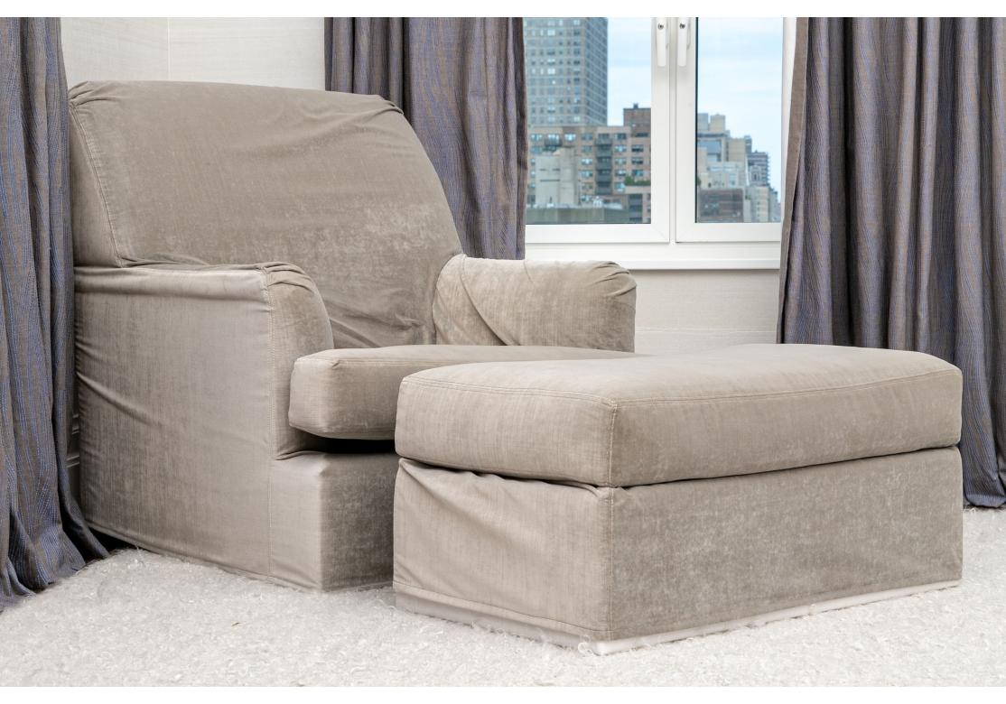 A very comfortable Chair and Ottoman custom slipcovered in a plush Pale Gray Shirred Velvet style fabric with a particularly soft hand. Both Chair and Ottoman are oversized and create a complete Nest of comfort for relaxing, reading or watching a