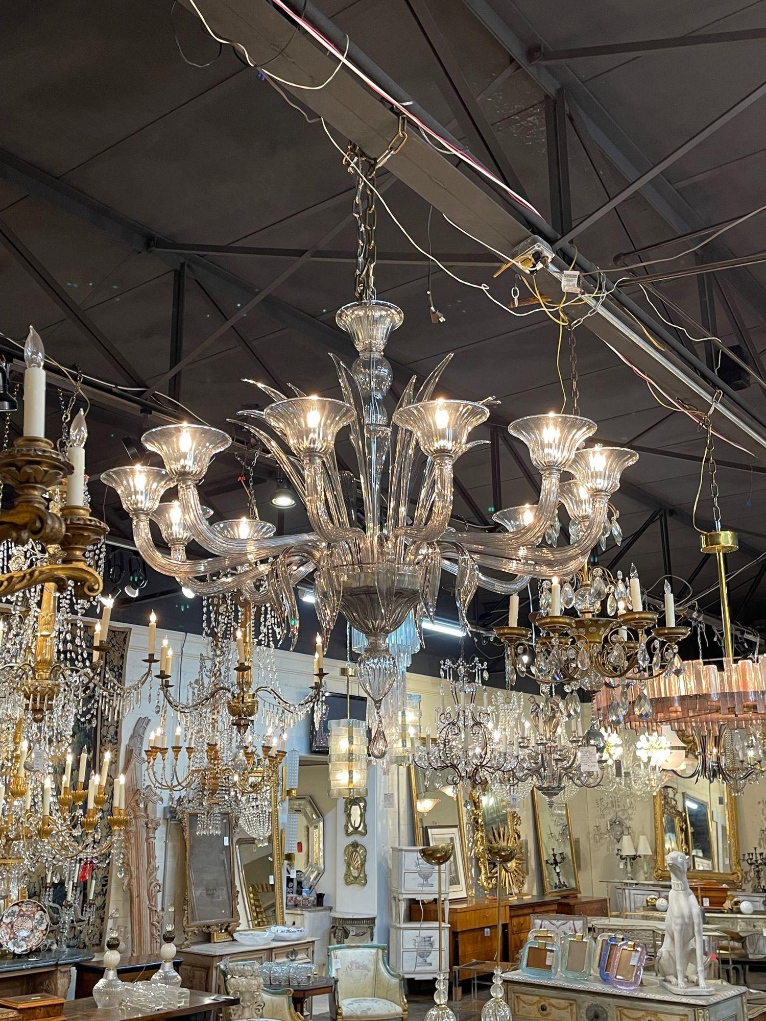Exceptional modern smoke colored Murano glass chandelier with 12 lights. Beautiful scale and shape and leaf like pieces of glass in the center of the fixture. Stunning!!.