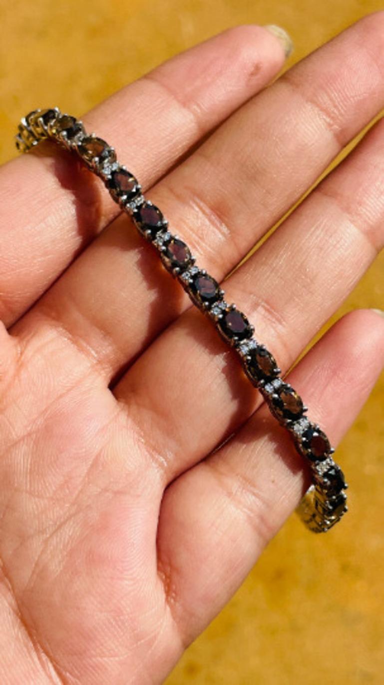 Modern Smoky Topaz and Diamond Tennis Bracelet in sterling silver showcases endlessly sparkling natural smoky topaz, weighing 8.96 carat. It measures 7.5 inches long in length. 
Smoky Topaz stimulate concentration and reduces stress. 
Designed with