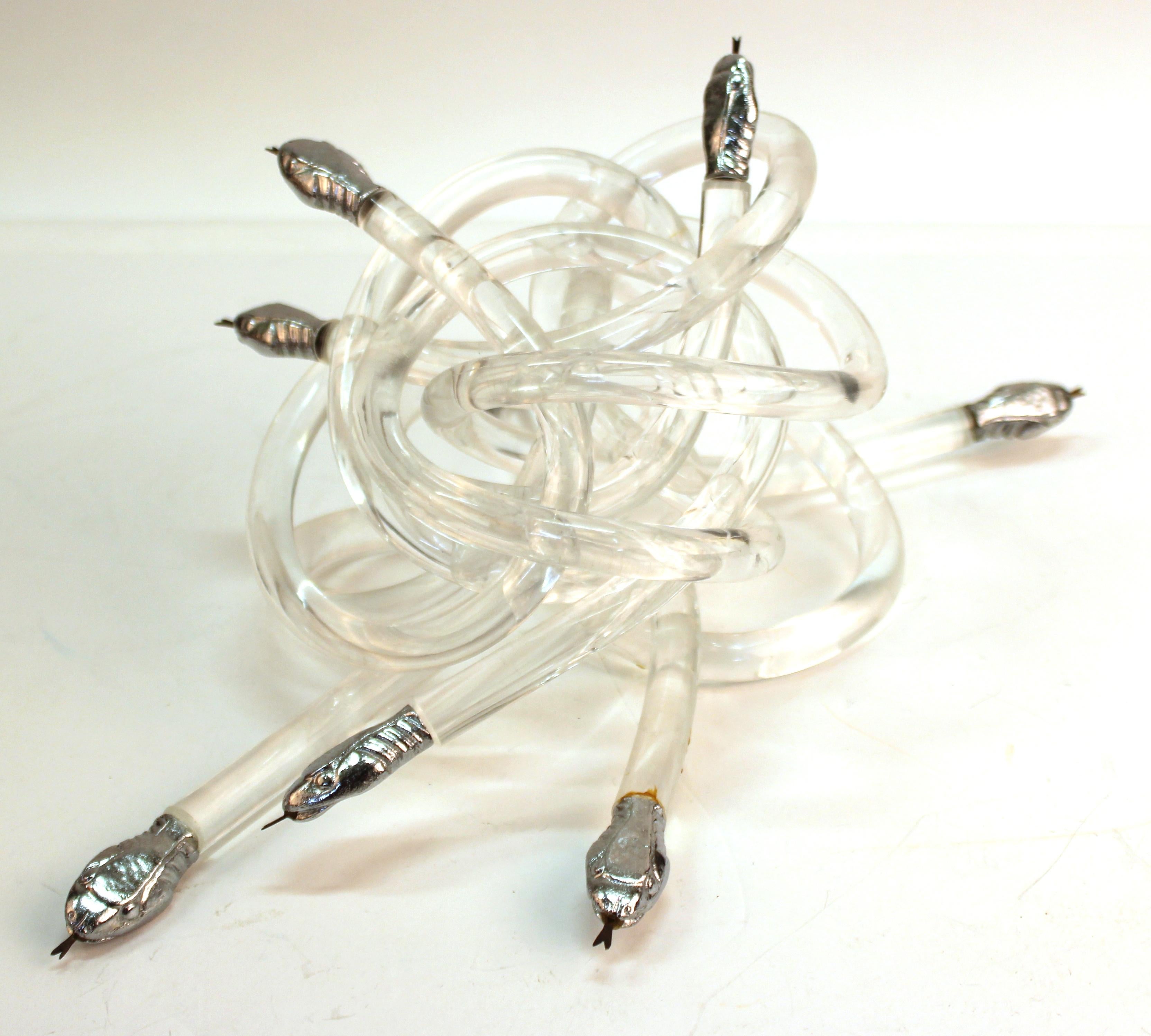 Modern sculpture consisting of snakes with bodies in clear acrylic with metal heads, knotted together into a small mount. The piece is unmarked and in great vintage condition, with age-appropriate wear.