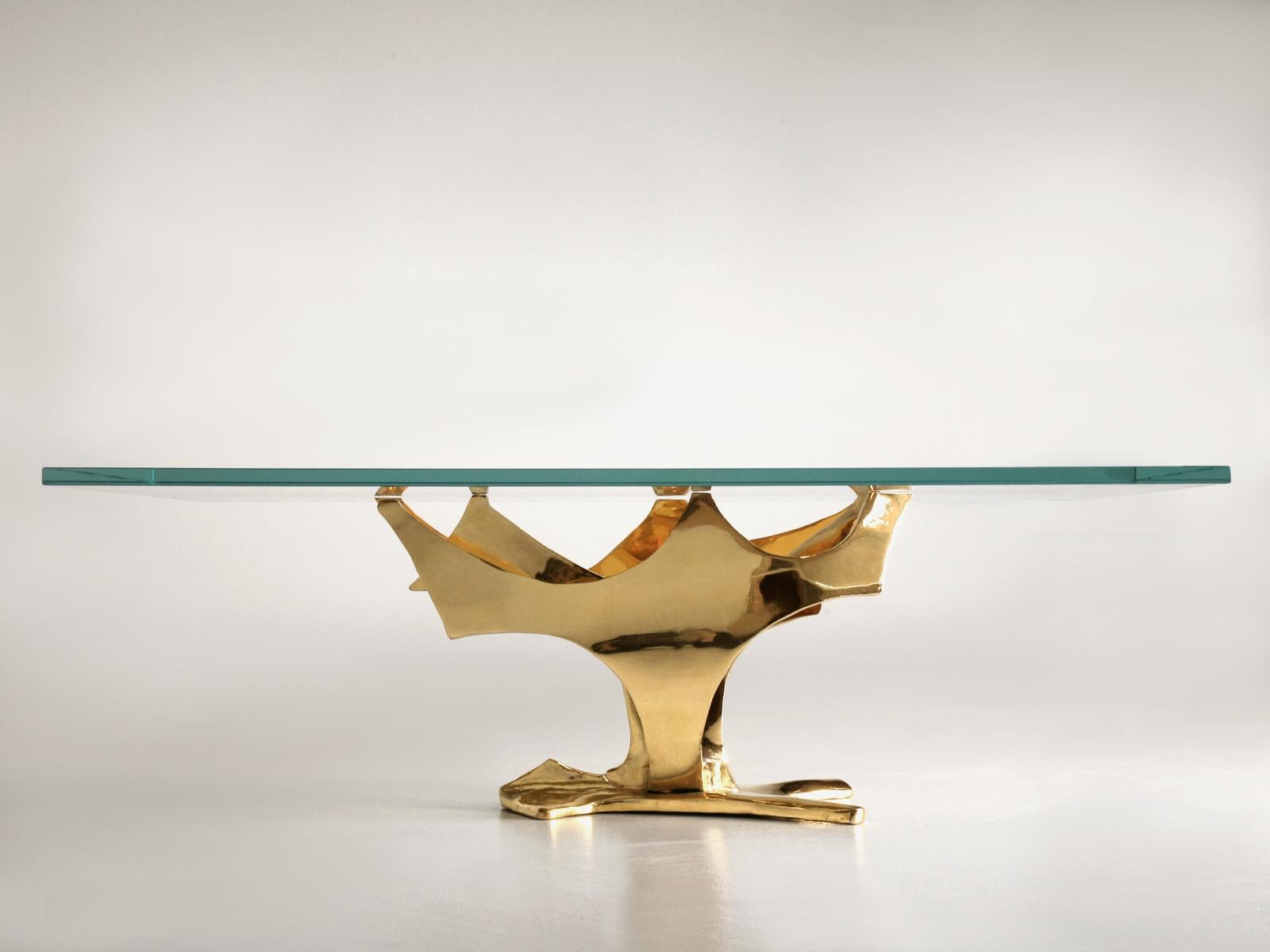 Created by the Old Plank group of artisans, this spectacular coffee table base is 24-karat gold over solid bronze. The design is free-form so every base is slightly different; call it unique - the thick glass top allows the exquisite sculptural form