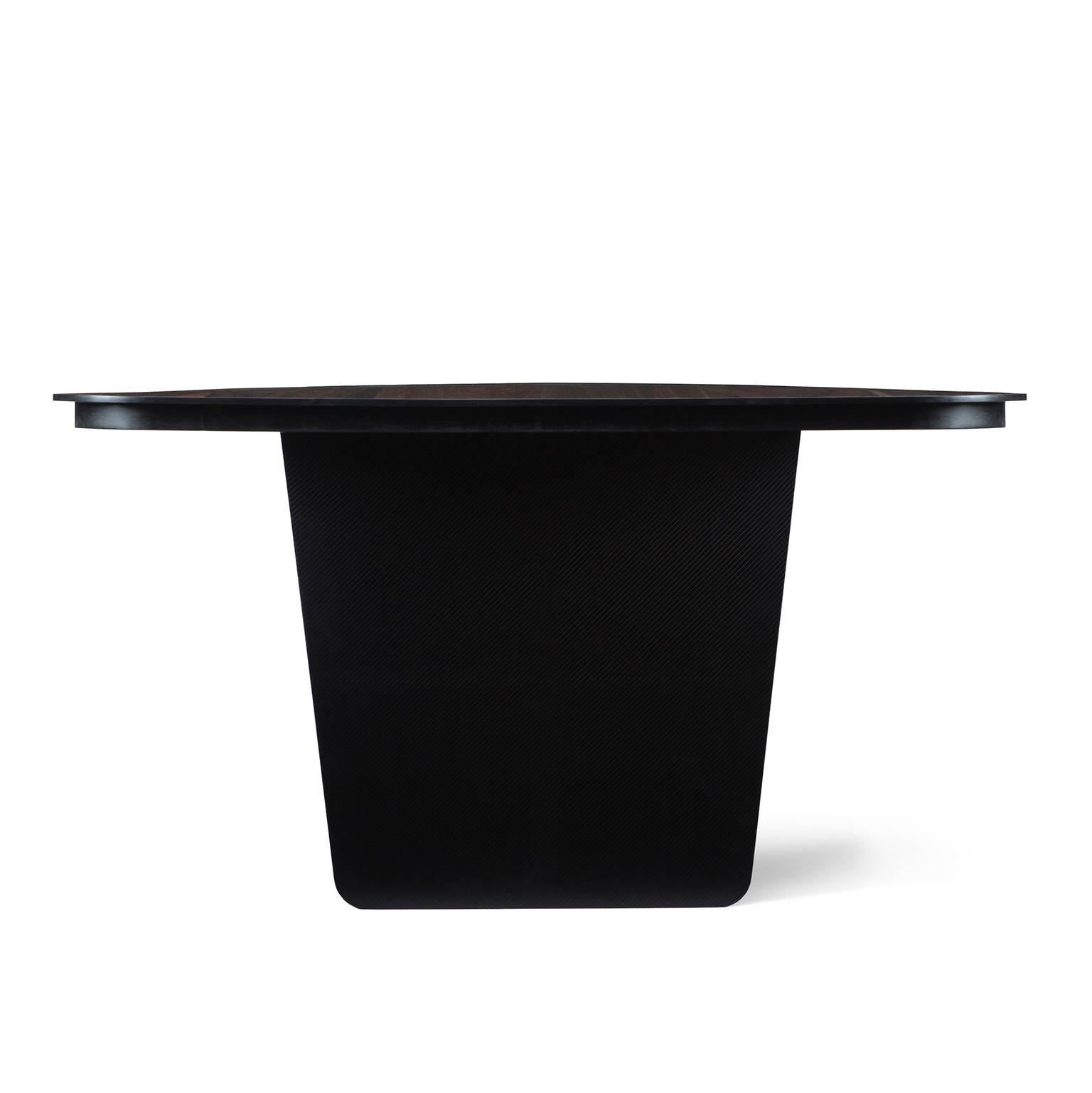 Carbon Claro, lightweight at the sight, robust in the structure. The Carbon Claro table features a precious solid charred claro walnut combined top with thin carbon legs in different color finishes. The two elements connect seamlessly in a