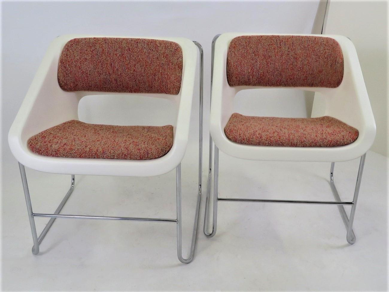 Pair of Space Age Mid Century Modern armchairs created by Paul Boulva for the Montreal Olympics in 1976 and produced by Artopex of Canada. The chairs sport a chromed metal frame with molded plastic seat with back and seat upholstered. The chairs are