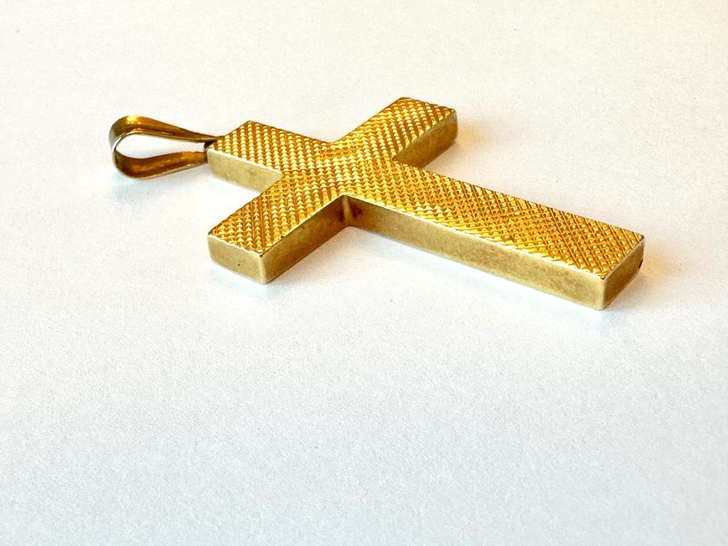 Beautiful 18kt yellow gold cross from Spain. This pendant is worked with the relief technique. Relief is the height of a jewelry feature as it rises above or sinks below the background level of the piece. Cameos and intaglios are examples of the