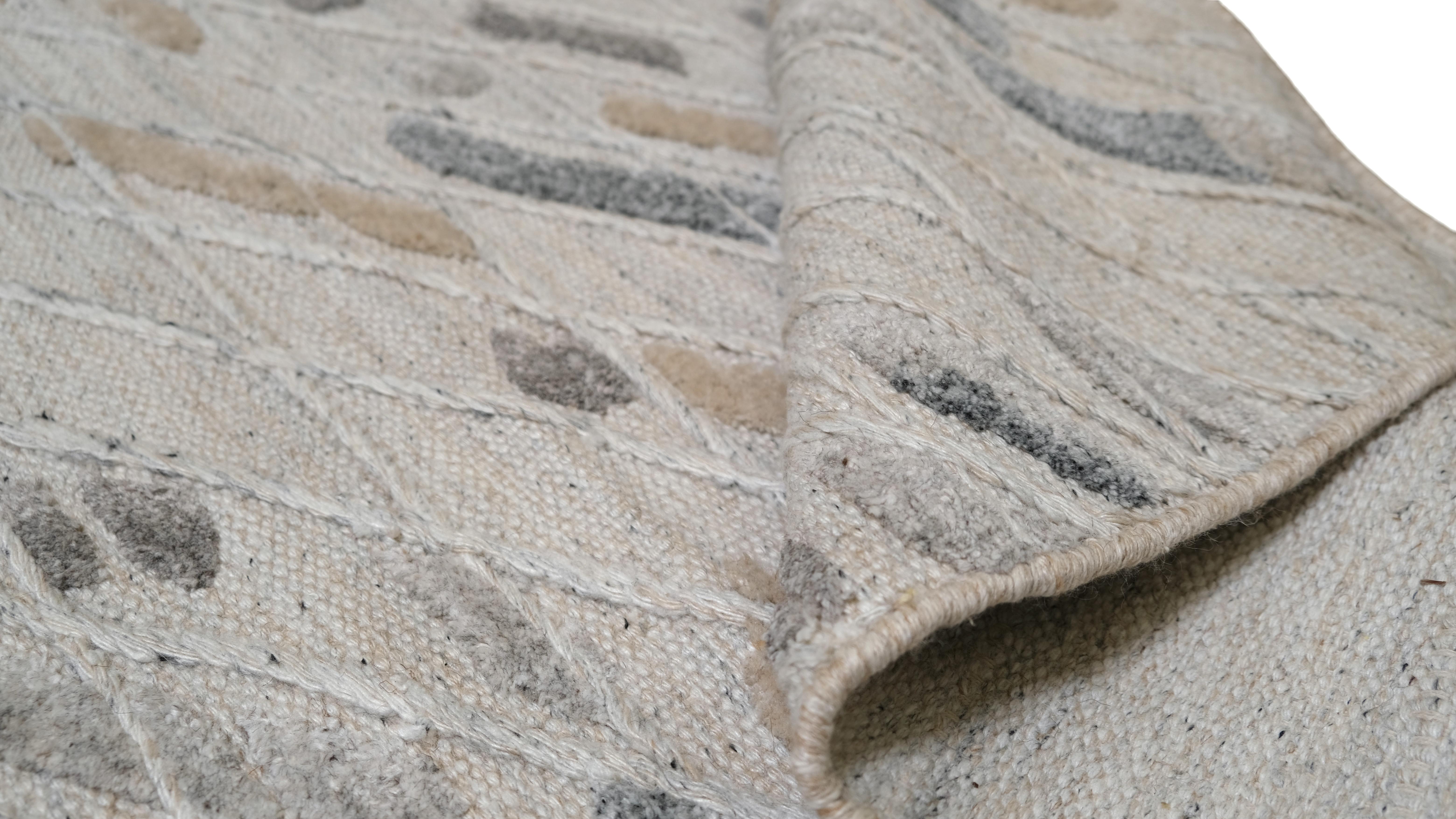 Introduce a subtle yet dynamic statement to your space with this rug, featuring a captivating speckled design in soft neutral tones of beige, grey and taupe. The pattern, reminiscent of scattered brushstrokes, is complemented by diagonal lines,